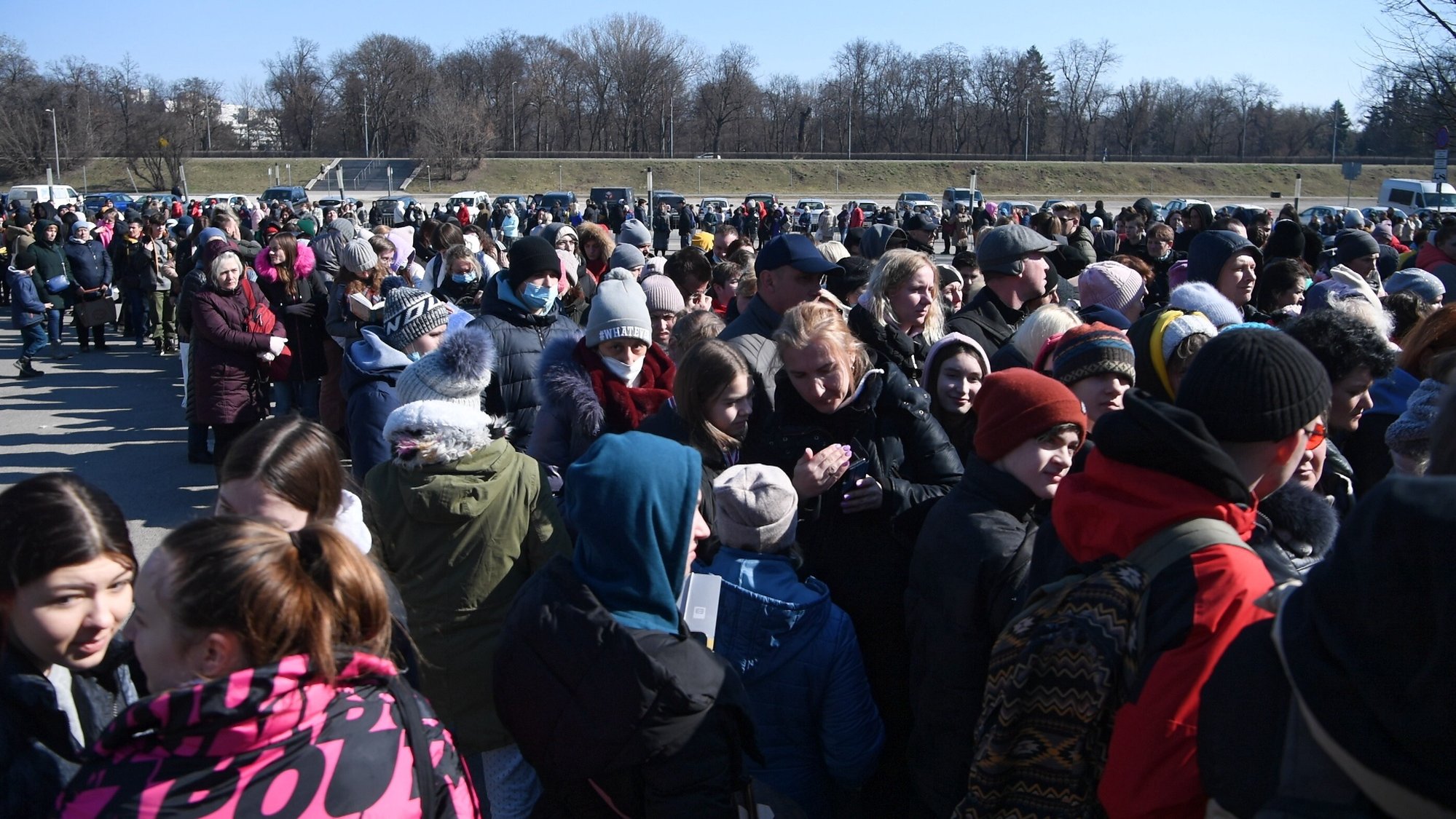 epa09837636 Refugees from Ukraine queue to the PESEL number issuance point at the National Stadium in Warsaw, Poland, 20 March 2022. Polish president Duda has signed into law an amended bill on assistance to Ukrainians fleeing the Russian invasion. Under the bill, refugees from Ukraine will receive the PESEL (Universal Electronic System for Registration of the Population) national identification number. Since 24 February, when Russia invaded Ukraine, over two million people have crossed the Polish-Ukrainian border into Poland, according to figures reported by the Border Guard on 20 March.  EPA/PIOTR NOWAK POLAND OUT