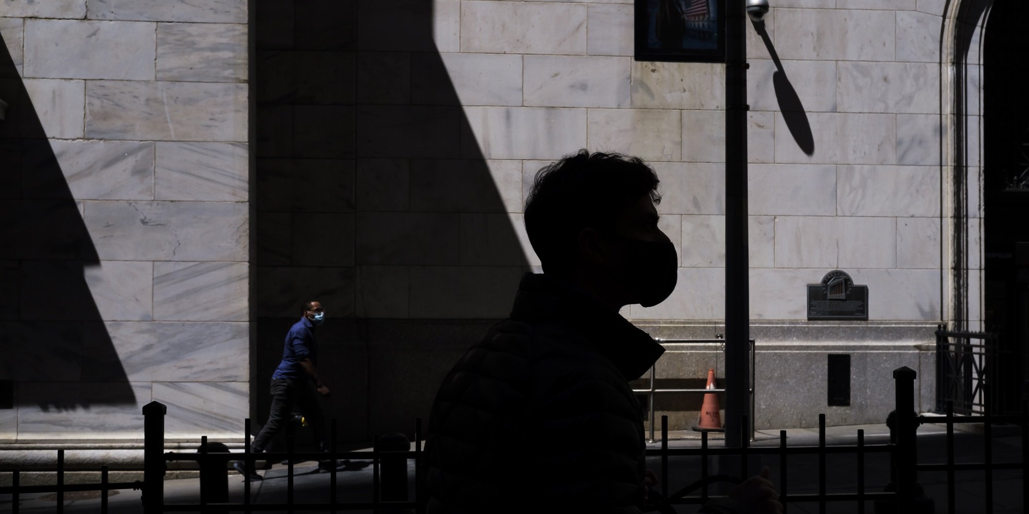 epa09162377 A person walks by the New York Stock Exchange in New York, New York, USA, 26 April 2021.  EPA/JUSTIN LANE