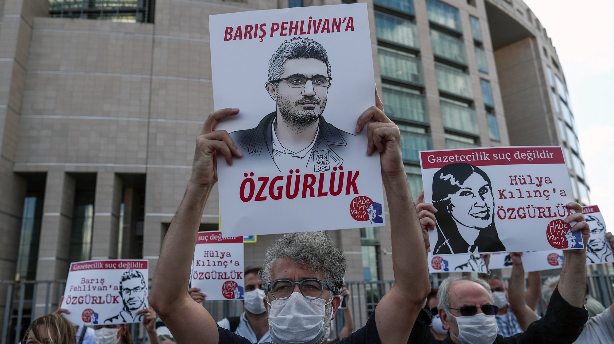 epa08656008 People hold posters depicting jailed journalists during a protest before a trial of jailed journalists in front of the Caglayan courthouse in Istanbul, Turkey,  09 September 2020. According to Reporters Without Borders, 30 journalists are in prison in Turkey.  EPA/SEDAT SUNA