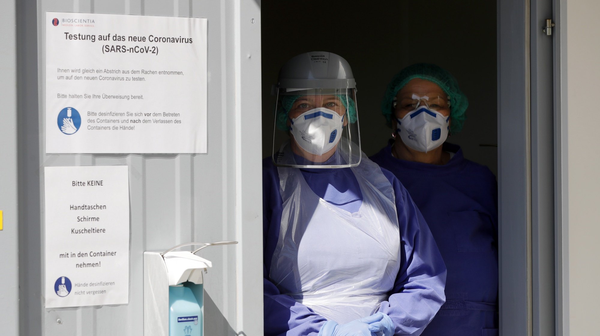 epa08379395 Employees wear protective face masks inside of the Corona smear centre at Bioscientia Healthcare GmbH in Ingelheim, Germany, 23 April 2020. The largest medical laboratory in Rhineland-Palatinate, Bioscientia Healthcare GmbH in Ingelheim, is one of the performance centres for corona diagnostics in Germany. In the laboratory in Ingelheim, up to 3,500 PCR examinations for the coronavirus are carried out daily. Countries around the world are taking increased measures to stem the widespread of the SARS-CoV-2 coronavirus which causes the Covid-19 disease.  EPA/RONALD WITTEK