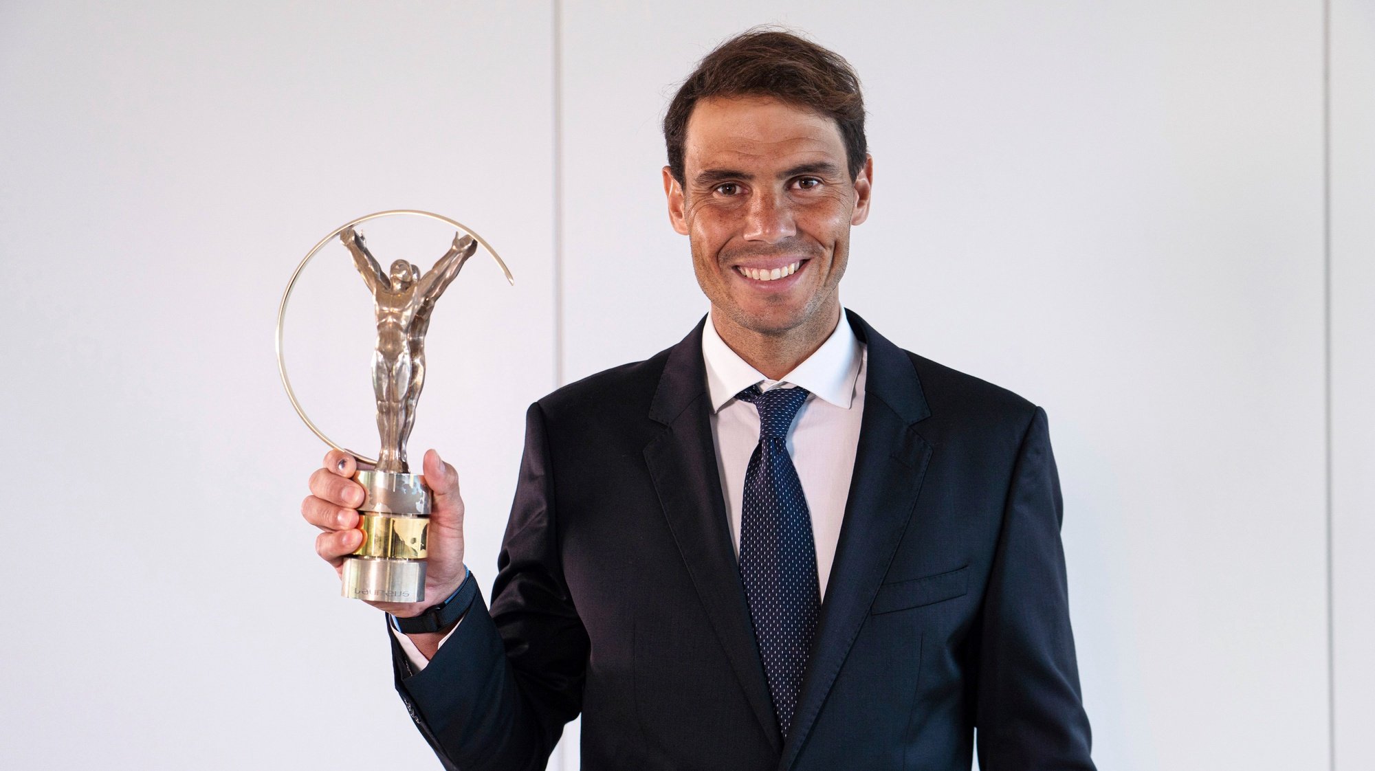 epa09181804 A handout photo made available by Laureus 2021 Awards shows Spanish tennis player Rafael Nadal as he poses with the Sportsman of the Year trophy during the virtual award ceremony of the Laureus 2021 Awards held in Seville, southern Spain, 06 May 2021.  EPA/Ernesto Castillo  HANDOUT EDITORIAL USE ONLY/NO SALES