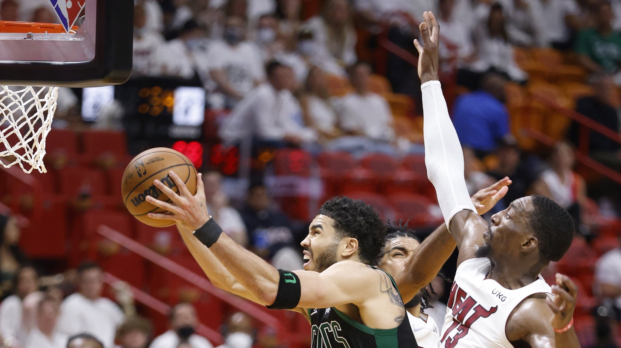 epa09976250 Boston Celtics forward Jayson Tatum (L), shoots around Miami Heat center Bam Adebayo (R), and guard Gabe Vincent (C), during the second half of Game 5 of the NBA Eastern Conference Finals series between the Miami Heat and the Boston Celtics at FTX Arena, in Miami, Florida USA, 25 May 2022.  EPA/RHONA WISE  SHUTTERSTOCK OUT