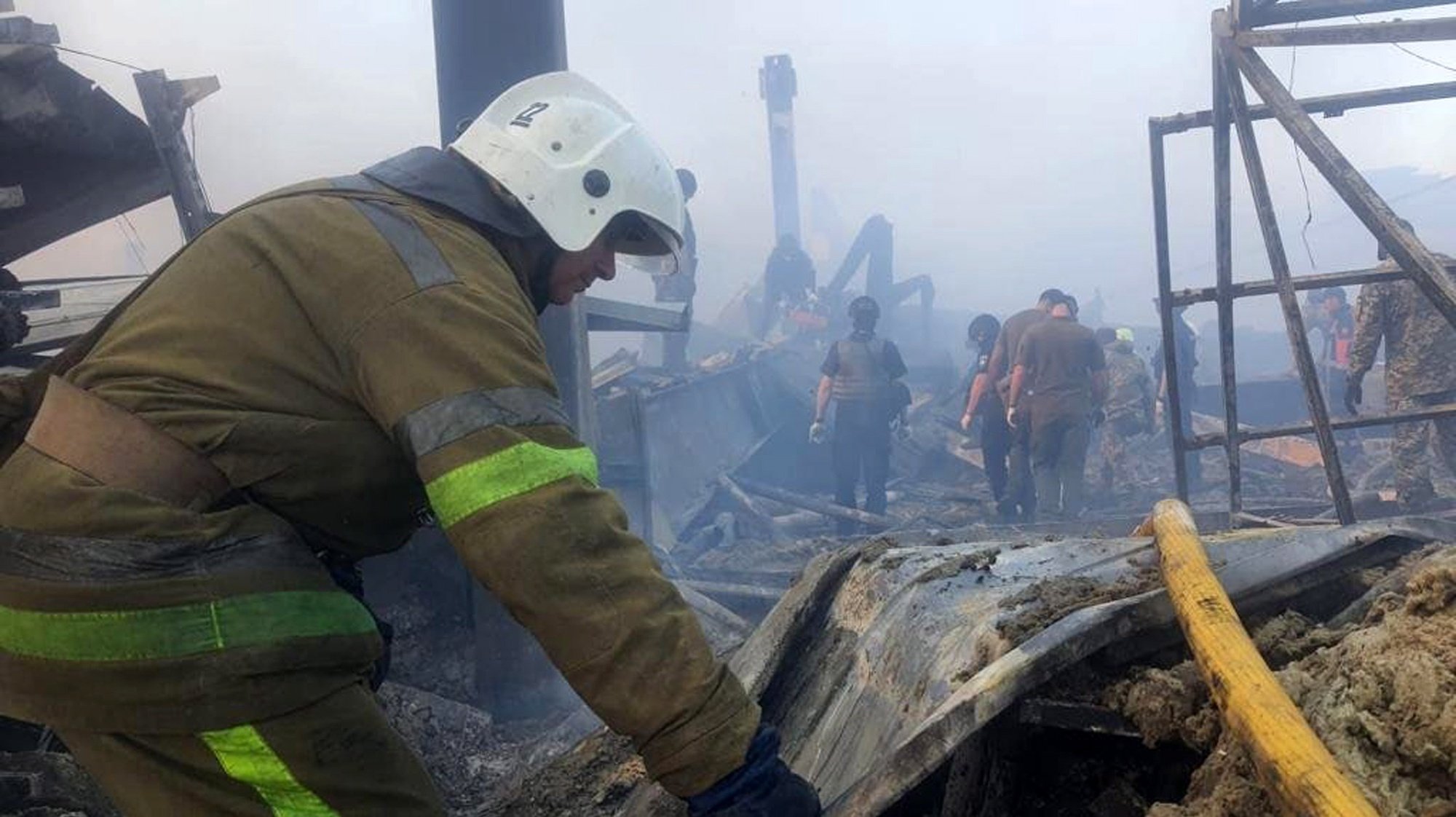 epa10037221 A handout photo released by the press service of the State Emergency Service (SES) of Ukraine shows firefighters and rescue services working to extinguishe a fire at a shopping center in Kremenchuk, Ukraine, 27 June 2022. The State Emergency Service (SES) of Ukraine said that the bodies of six dead persons were found at the spot of the Amstor shopping center fire following missile strikes. The one-story building of a shopping center was hit by rockets, the SES stated further.  EPA/STATE EMERGENCY SERVICE OF UKRAINE HANDOUT -- BEST QUALITY AVAILABLE -- MANDATORY CREDIT: STATE EMERGENCY SERVICE OF UKRAINE -- HANDOUT EDITORIAL USE ONLY/NO SALES