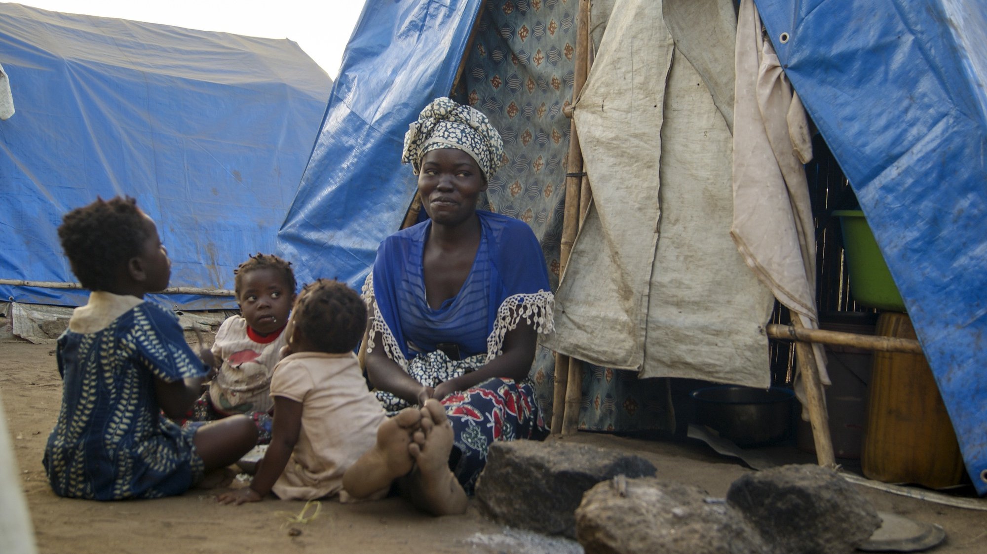 A woman and children in one of the shelter camps in Metuge, a space housing displaced people fleeing armed violence in northern Mozambique. Cabo Delgado, Mozambique, 16 August 2021 (issue on 17 August 2021). Following the attacks, which have terrorized Cabo Delgado province since 2017, there are more than 3,100 deaths, according to the ACLED conflict registration project, and more than 817,000 displaced people, according to Mozambican authorities. LUISA NHANTUMBO/LUSA