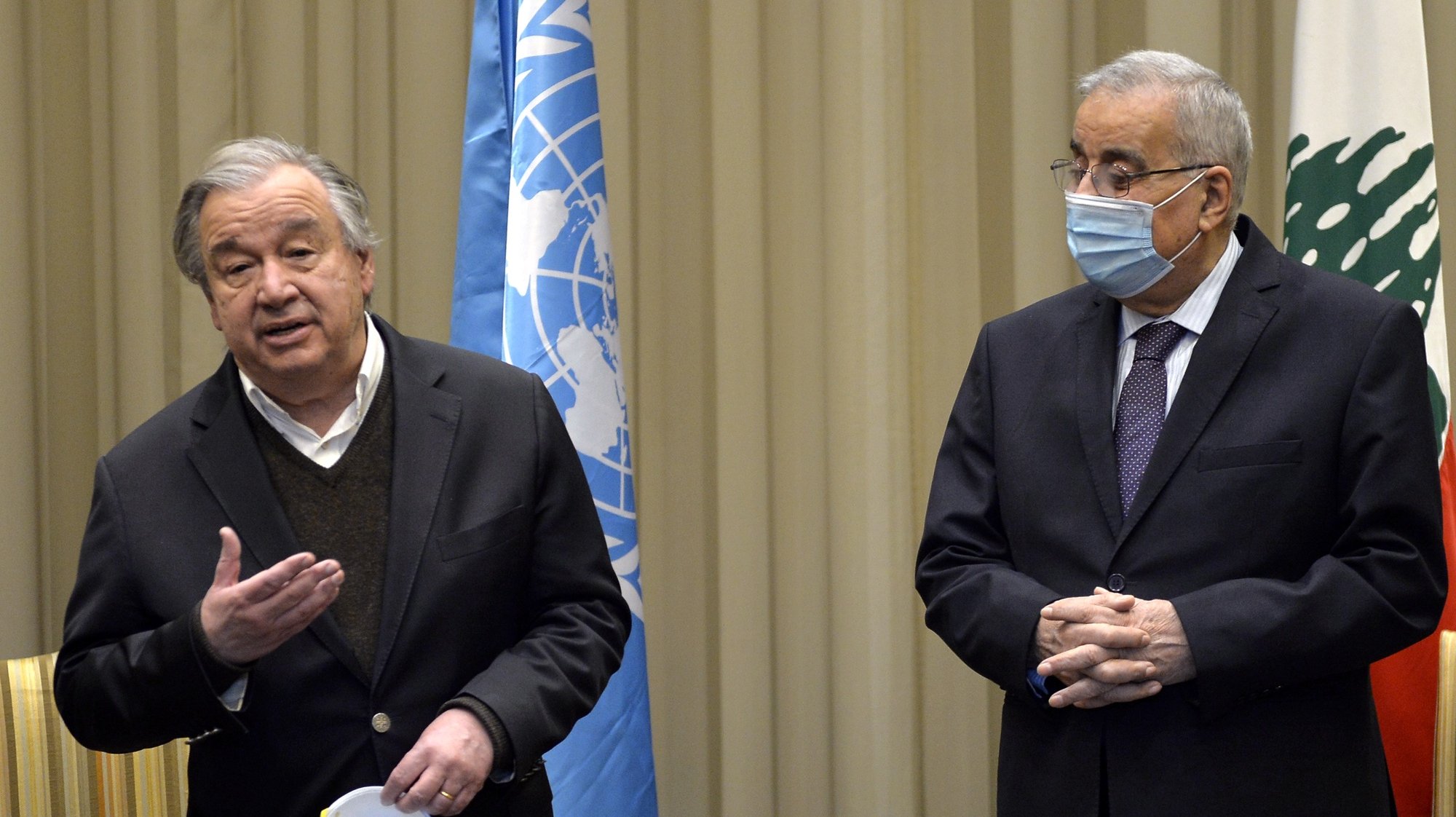 epa09649834 Lebanese Foreign Minister Abdallah Bou Habib (R) listens to Antonio Guterres (L), Secretary-General of the United Nations as he speaks to the media upon his arrival at the Rafik Hariri international airport in Beirut, Lebanon, 19 December 2021. Guterres visit Lebanon for four days to meet with Government officials, including President Michel Aoun, Speaker Nabih Berri, and Prime Minister Najib Mikati, as well as a number of religious leaders and civil society representatives and he will visit the UN Interim Force in Lebanon and tour parts of the Blue Line.  EPA/WAEL HAMZEH