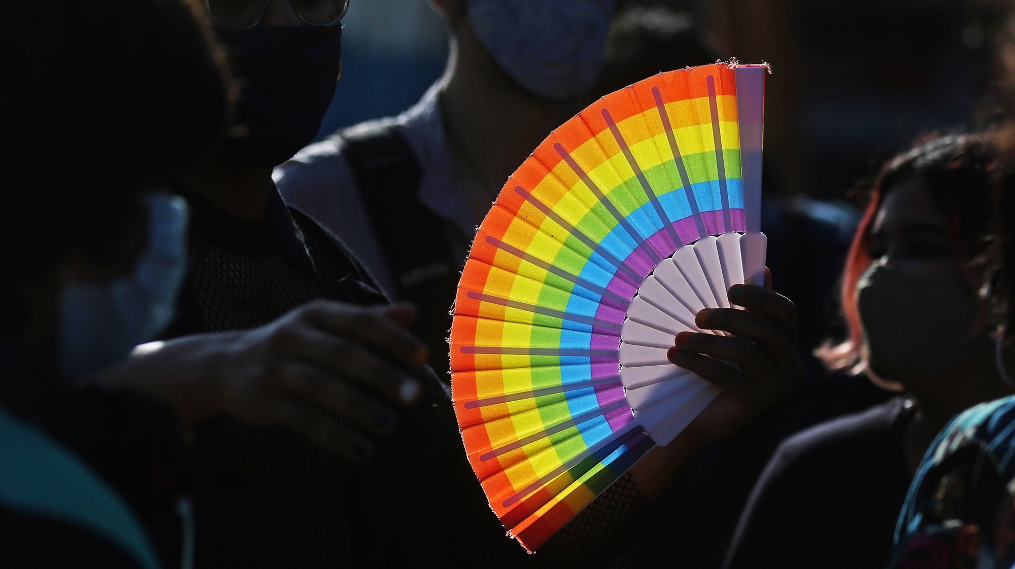 epa08906388 A participant holds a rainbow-colored fan during the LGBT (Lesbian, Gay, Bisexual, and Transgender) pride march in Bangalore, India, 27 December 2020. Hundreds of LGBTQ people and their supporters waved flags, beat drums, and danced to local tunes during the Bengaluru Namma Pride March. They called to end violence and oppression based on gender identity and sexual orientation and to end gender decriminalization.  EPA/JAGADEESH NV