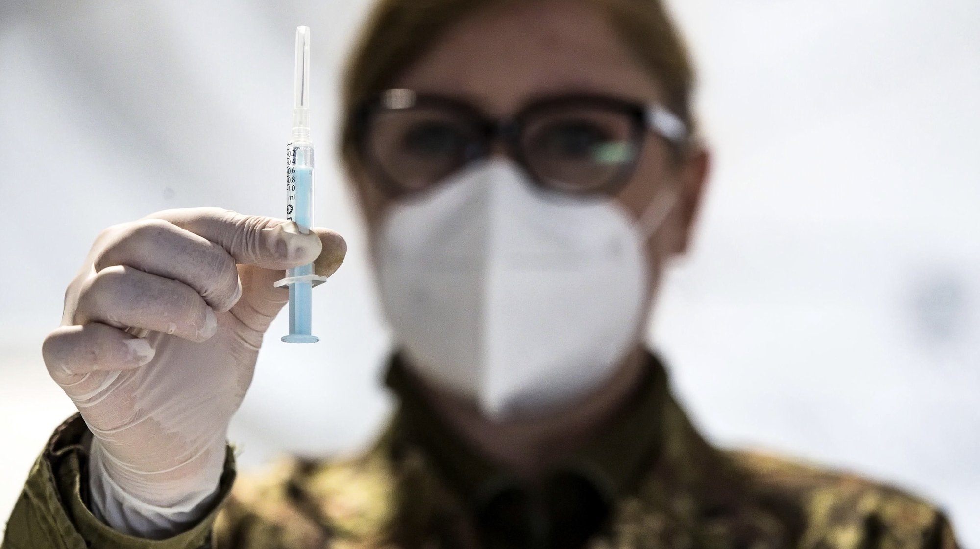 epa09085625 An Italian Army soldier shows a dose of the vaccine for vaccination against Covid-19 with AstraZeneca serum at Defence Vaccination Centre set up inside the military citadel of Cecchignola, Rome, Italy, 20 March 2021. EU member countries reintroduced the AstraZeneca Covid-19 vaccine in their inoculation campaigns following the European Medicines Agency (EMA) announcement of 18 March to uphold its approval of the vaccine. Some countries stopped giving the vaccine over fears there might be links between the vaccination against Covid-19 with the AstraZeneca vaccine and a rare number of blood clots.  EPA/ANGELO CARCONI  EPA-EFE/ANGELO CARCONI