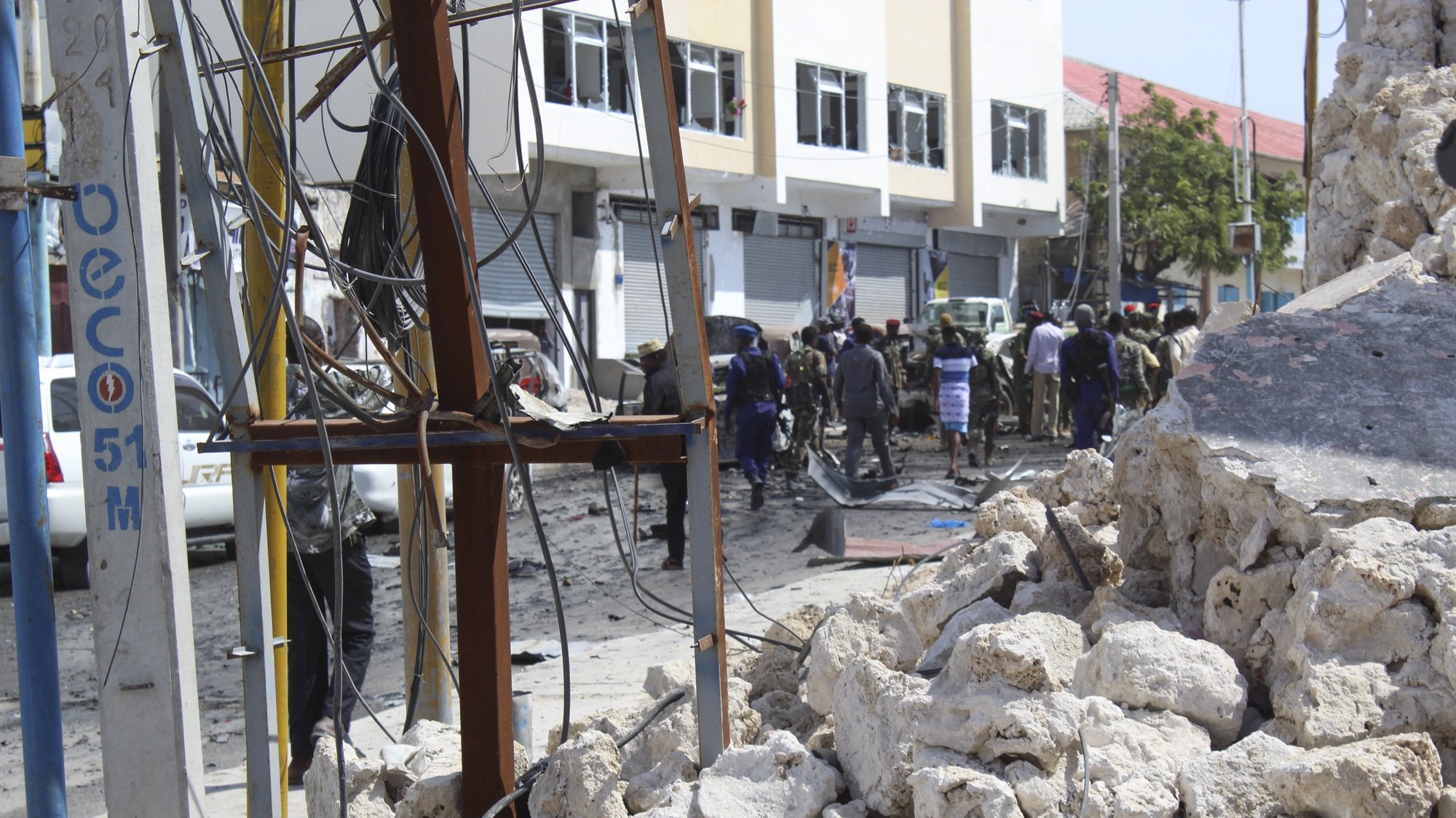 epa08111823 Rubbles are seen as people gather at the scene of a suicide car bomb explosion at a checkpoint near the parliament in Mogadishu, Somalia, 08 January 2019. At least four people have been killed in a latest attack claimed by Somalia&#039;s Islamist militant group al-Shabab.  EPA/SAID YUSUF WARSAME
