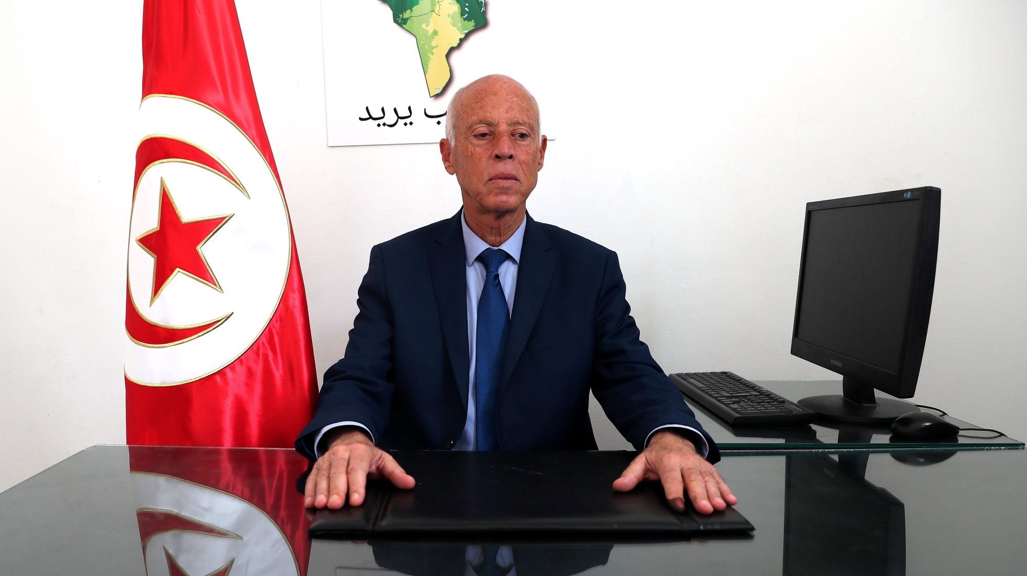 epa07846950 Tunisian presidential candidate Kais Saied poses for a photo at his campaign headquarters in Tunis, Tunisia, 16 September 2019. According to reports, preliminary results showed presidential candidates Kais Said, a 61-year-old law professor, and imprisoned businessman Nabil Karoui are leading the first round of voting and expected to face off in the second round in October.  EPA/MOHAMED MESSARA