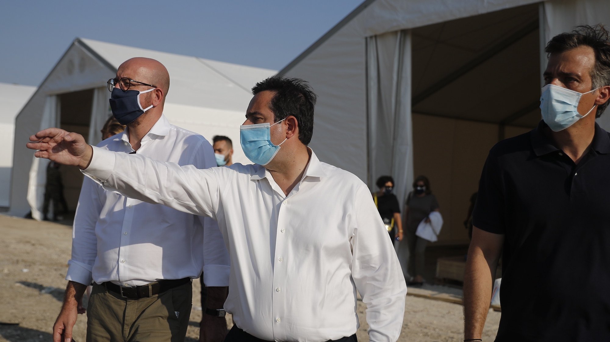 epa08670787 European Council President Charles Michel (C) walks with Greek Minister of Citizen Protection Michalis Chrisochoidis (2R) and Greek Minister for Immigration and Asylum Notis Mitarakis (1R) during his visit in the new refugees camp near Kara Tepe , on Lesbos island, Greece, 15 September 2020.  EPA/DIMITRIS TOSIDIS / POOL
