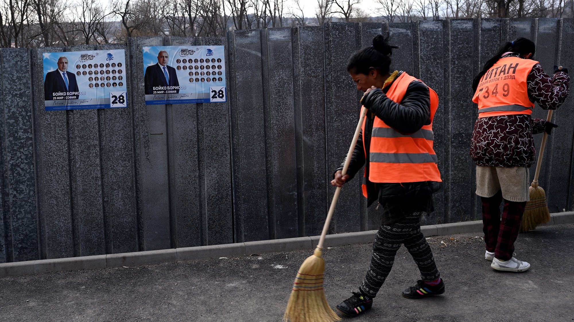epa09108202 Cleaning employees sweep in front of campaign posters of Bulgaria&#039;s centre-right ruling GERB party with pictures of Bulgarian Prime minister Boyko Borissov in Bankaj, Bulgaria, 31 March 2021. Bulgaria will hold parliamentary elections on 04 April 2021.  EPA/VASSIL DONEV