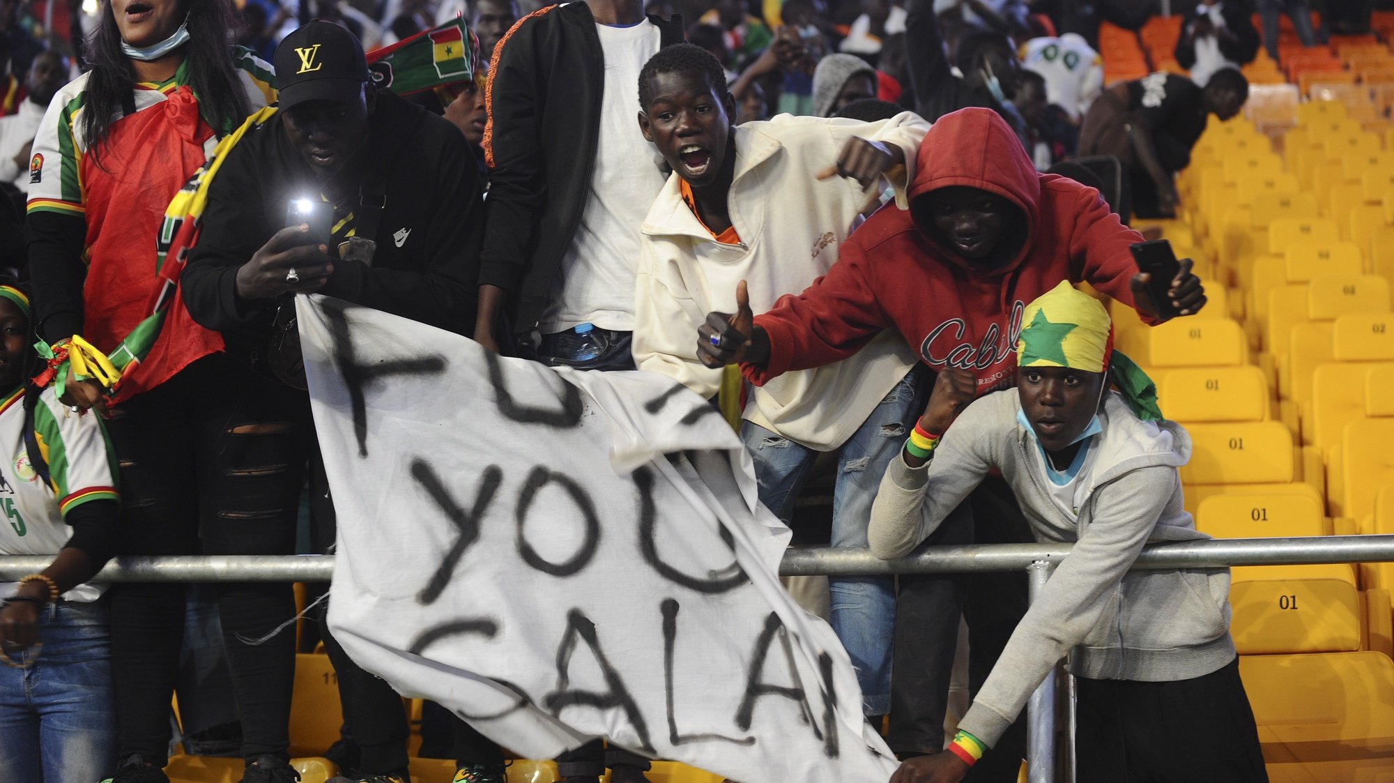 epa09859758 Senegal supporters celebrate winning the FIFA Qatar 2022 World Cup Africa qualifying match between Egypt and Senegal at the Diamniadio Olympic Stadium in Dakar, Senegal, 29 March 2022.  EPA/ALIOU MBAYE