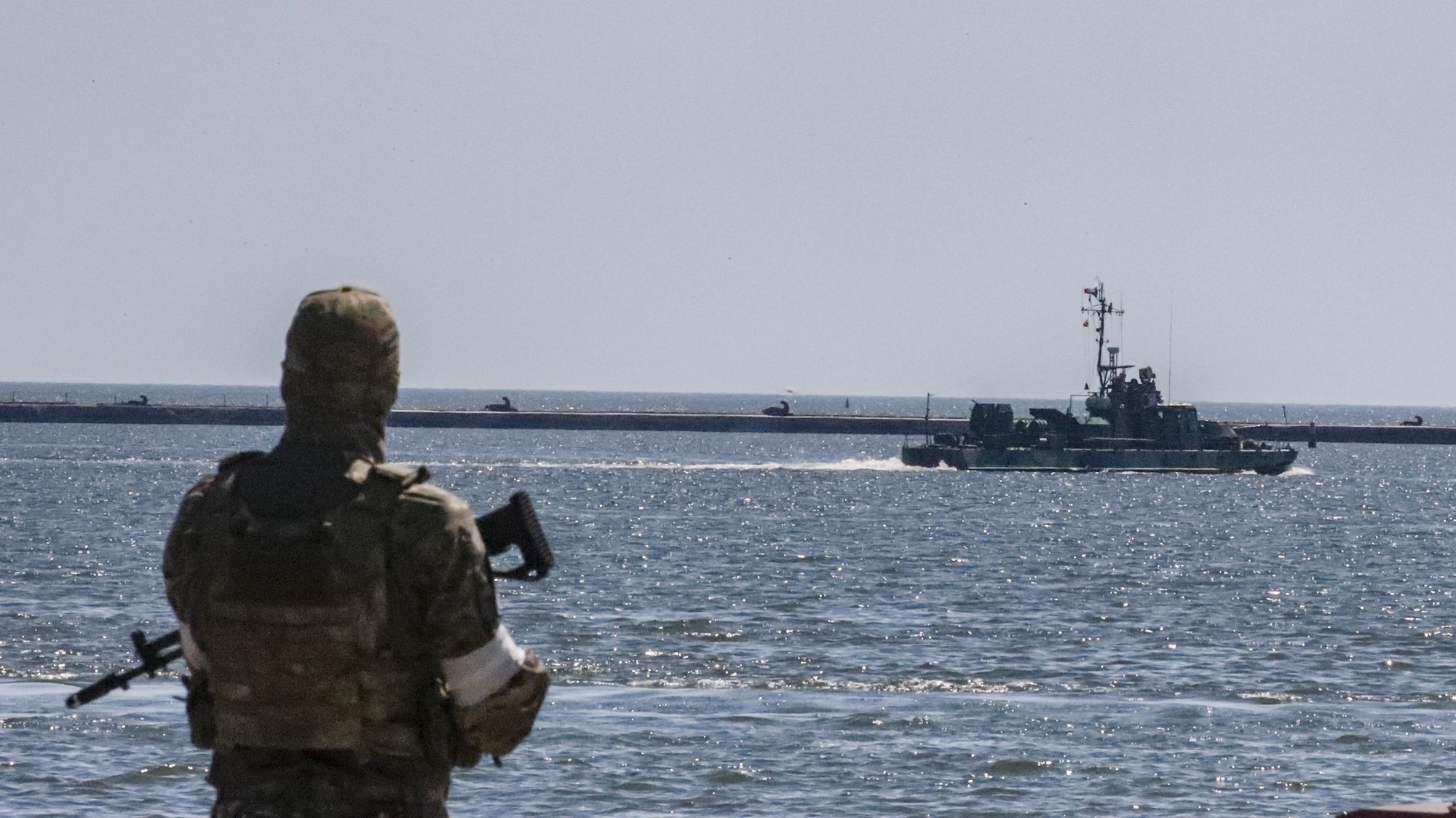 epa10009896 A picture taken during a visit to Mariupol organized by the Russian military shows a Russian navy ship sails in the waters of the cargo sea port of Mariupol, Ukraine, 12 June 2022.  Russian Defense Minister Sergei Shoigu said the seaports of Mariupol and Berdyansk in Ukraine are operating normally and are ready to ship grain.  According to Shoigu, demining of the Mariupol seaport has been completed and it is functioning normally and has received the first cargo ships. Shoigu added ‘In Mariupol, water and electricity supply to residential areas are gradually being restored, streets are being cleared, the first social facilities have begun to function.’ On 24 February Russian troops entered Ukrainian territory starting a conflict that has provoked destruction and a humanitarian crisis. According to the UNHCR, more than six million refugees have fled Ukraine, and a further 7.7 million people have been displaced internally within Ukraine since.  EPA/SERGEI ILNITSKY