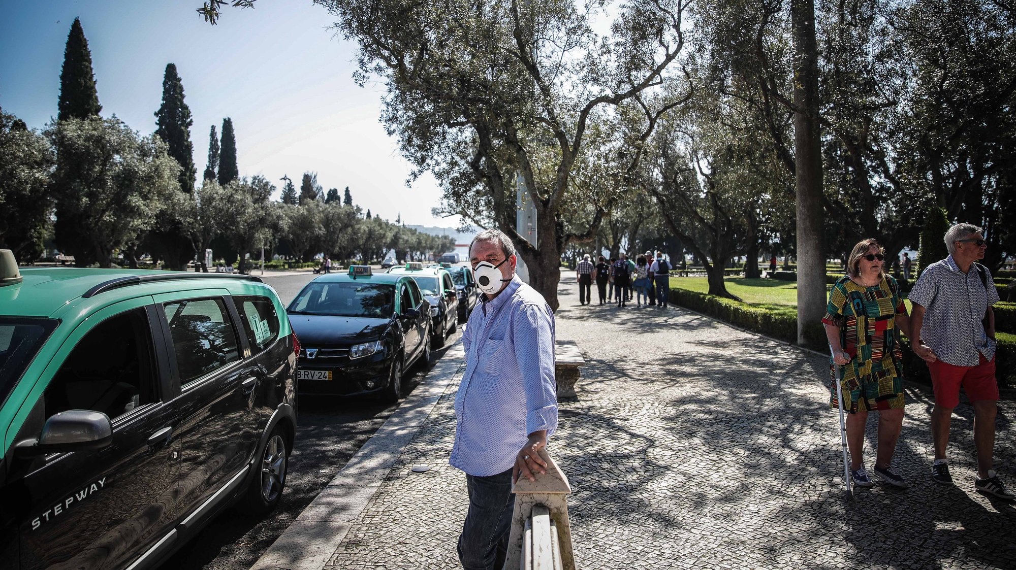 A taxi driver wears a protective mask as he waits outside Jeronimos Monestary which was closed due to the ongoing pandemic of the COVID-19, Lisbon, Portugal, 14 March 2020. The number of COVID-19 infections throughout Portugal has risen to 169. MÁRIO CRUZ/LUSA