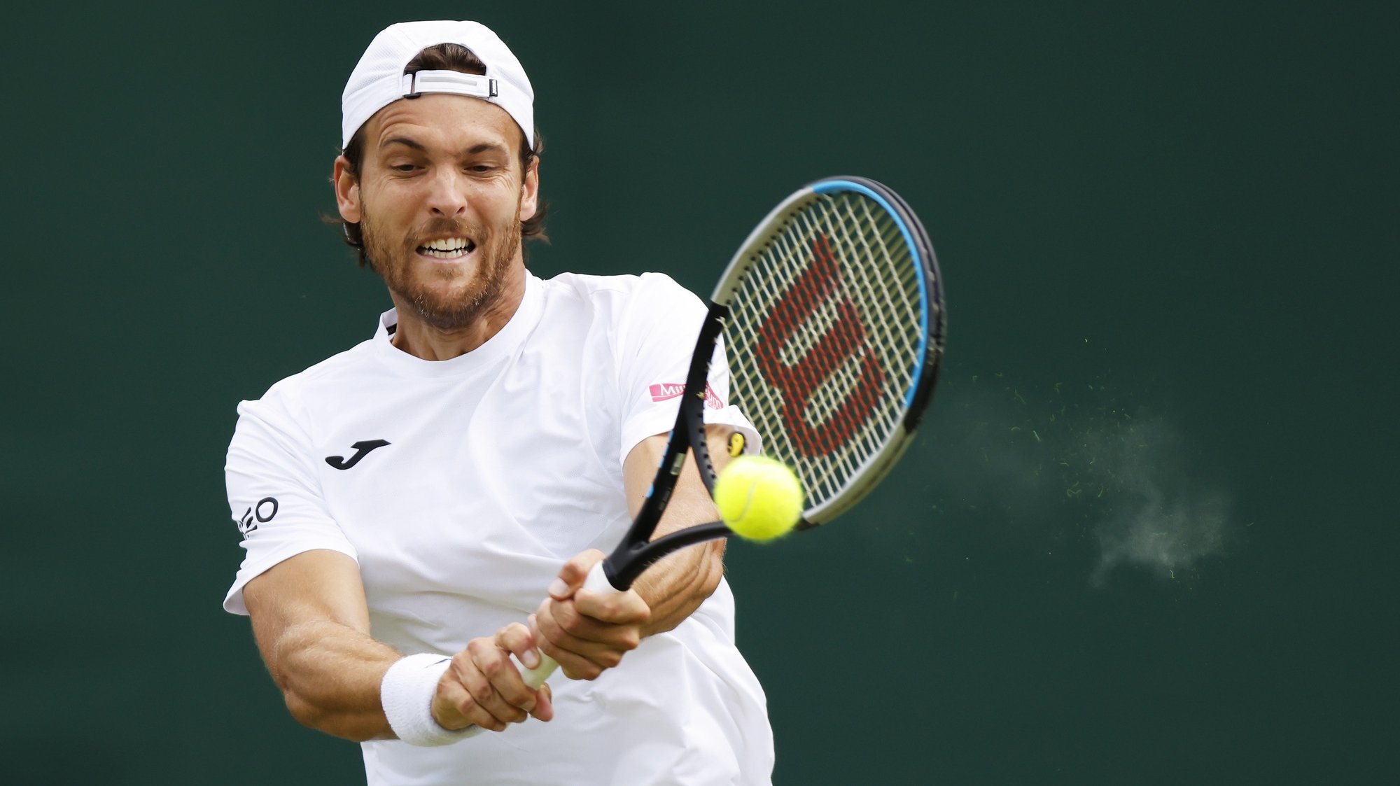 epa10038519 Joao Sousa of Portugal hits a backhand in the men&#039;s first round match against Richard Gasquet of France at the Wimbledon Championships, in Wimbledon, Britain, 28 June 2022.  EPA/TOLGA AKMEN   EDITORIAL USE ONLY