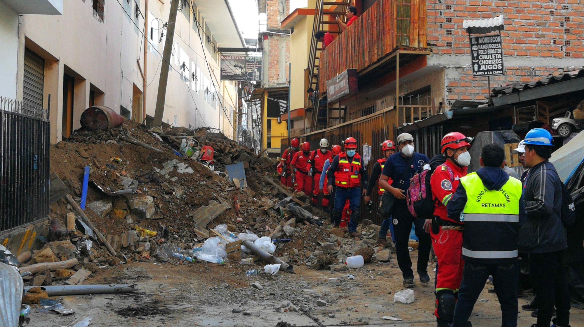epa09827816 Rescue teams gather near a landslide on a street in Retamas, in Pataz, Peru, 15 March 2022. Seven people are missing and about sixty houses are buried in the Peruvian province of Pataz, the National Police reported. Peruvian President Pedro Castillo posted on Twitter &#039;I have arranged for the head of the National Civil Defense Institute and the Minister of Defense to go to the area affected by the landslide in the province of Pataz, in the La Libertad region. We will support the affected families and coordinate various actions with the local authorities,&#039;.  EPA/Audias Torres Coronel