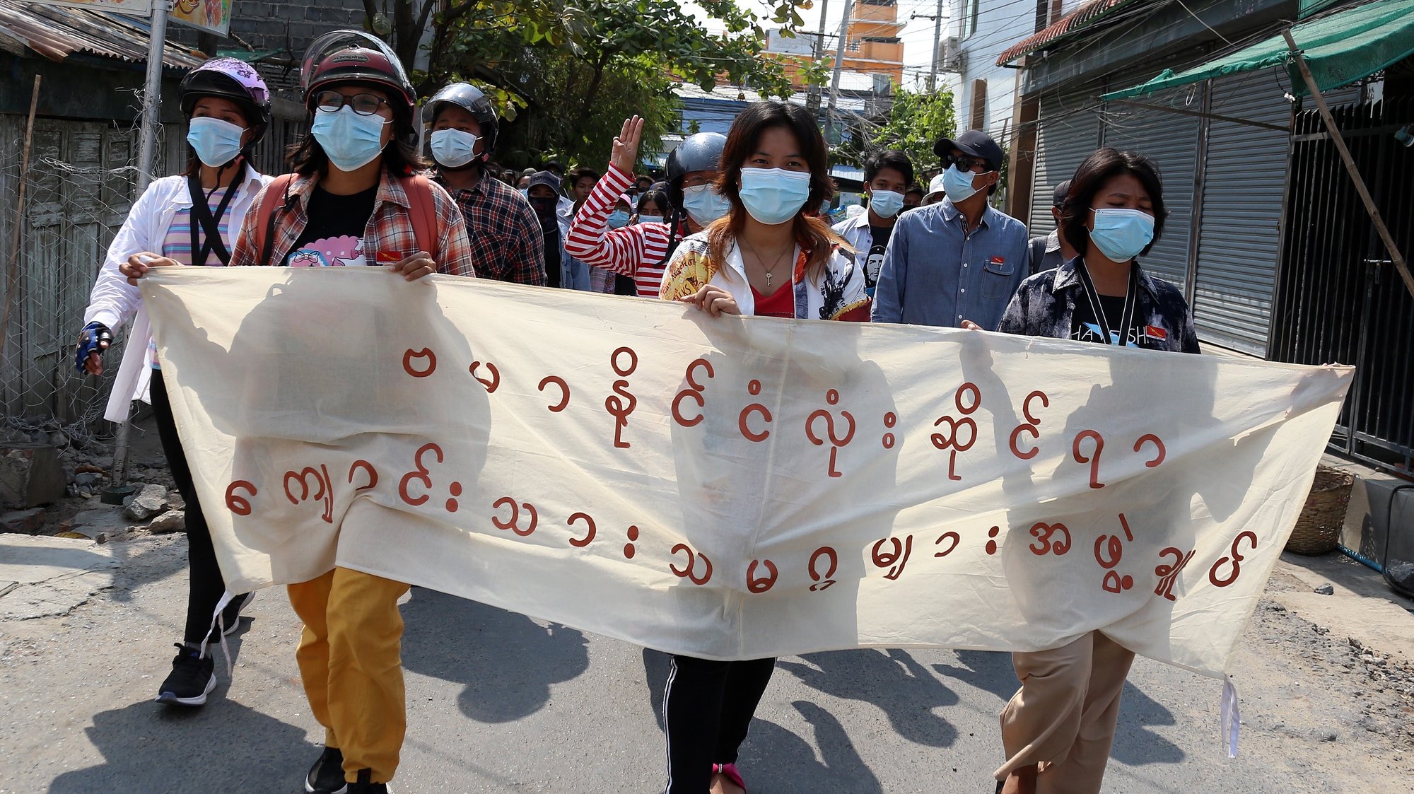epa09123668 Demonstrators hold a banner reading &#039;All Burma Federation of the Student Unions&#039; during an anti-military coup protest in Mandalay, Myanmar, 09 April 2021. According to the Assistance Association for Political Prisoners (AAPP), at least 570 people have been killed by Myanmar armed forces since the military seized power on 01 February 2021 while protests continue despite the intensifying crackdown on demonstrators.  EPA/STRINGER