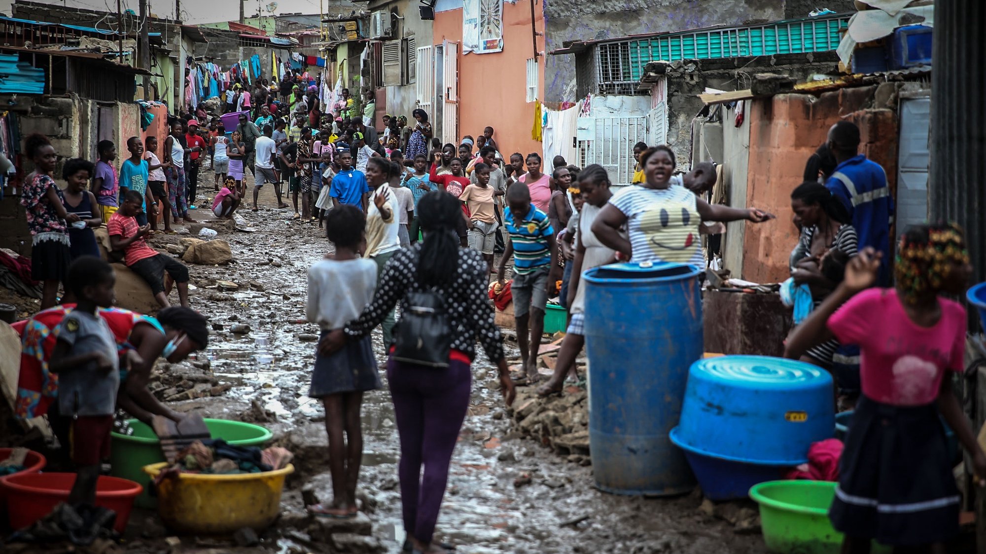 People on a muddy street after heavy rain that fell Monday night in Encide neighborhood, in the Sambizanga district, on the outskirts of Luanda, Angola, 20 April 2021. The torrential rains that hit Luanda on Monday killed 14 people and left 8,000 homeless, with 16 houses collapsed, 15 trees fell, and a bridge was destroyed, among other damages yet to be calculated. AMPE ROGERIO/LUSA