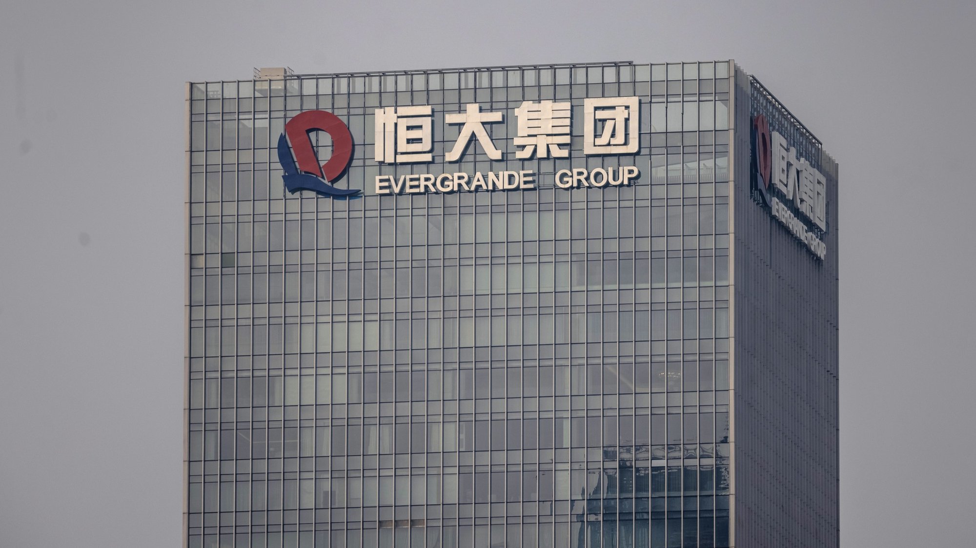 epa09499591 A Evergrande Group headquarters building is seen in Shenzhen, Guangdong province, China, 1 October 2021. To reassure investors, China Evergrande Group, the worldâ€™s most indebted property developer, has made several posts on its official social media this week claiming it has resumed work on 46 real estate projects in cities across China. Evergrande said this week that it plans to sell almost 20% of Shengjing Bank to a Chinese state-owned enterprise. In order to solve its upcoming liabilities, the company is trying to sell other assets such as an office building in Hong Kong, a property management services firm, and stakes in an electric-vehicle business.  EPA/ALEX PLAVEVSKI