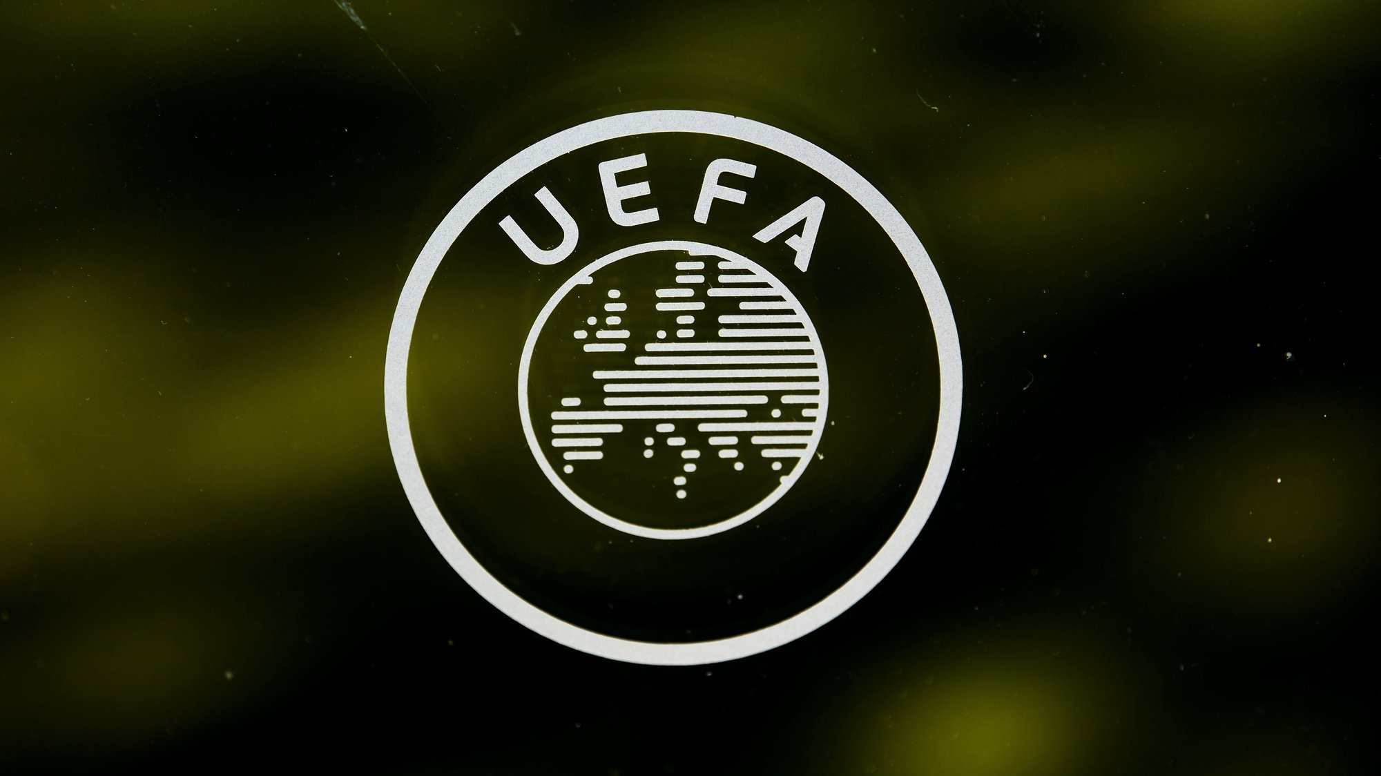 epa08289437 (FILE) - A UEFA logo is pictured through a window prior to the UEFA Europa League 2019/20 Round of 16 draw, at the UEFA Headquarters in Nyon, Switzerland, 28 February 2020 (re-issued 12 March 2020). The UEFA announced on their website on 12 March 2020 that they have invited representatives of its 55 member associations, together with the boards of the European Club Association and the European Leagues and a representative of FIFPro, to attend meetings by videoconference on Tuesday 17 March to discuss European football&#039;s response to the coronavirus outbreak.  EPA/JEAN-CHRISTOPHE BOTT *** Local Caption *** 55912791