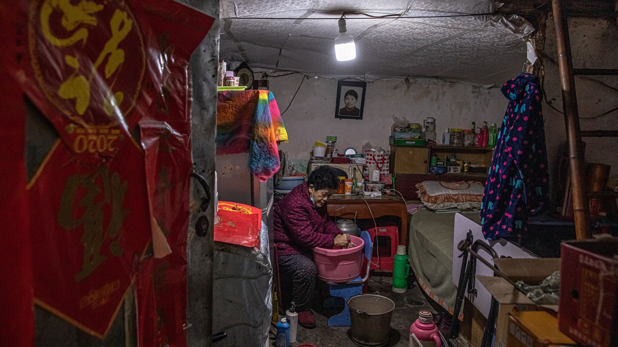 epa08957100 An elderly woman at her house in a residential area of Wuhan, China, 22 January 2021. The day 23 January 2021 marks the one-year anniversary of the start of a strict 76-day lockdown of the Chinese city of Wuhan where the coronavirus was first discovered before spreading across the world into a deadly global pandemic.  EPA/ROMAN PILIPEY
