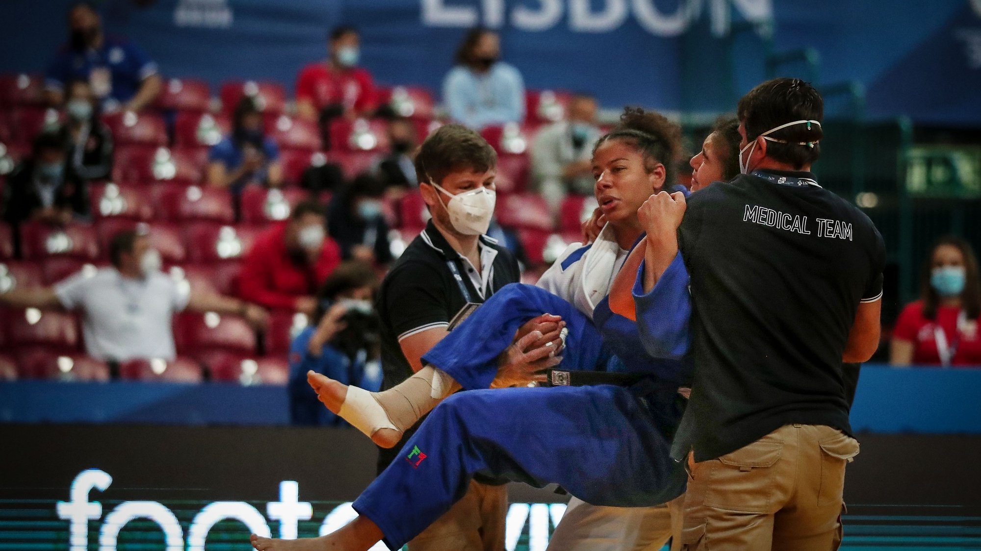 Patrícia Sampaio of Portugal (blue) is taken from tatami by Audrey Tcheumeo of France (white) and medical team after a injury during the repechage round in the women&#039;s -78kg category at the European Judo Championships in Lisbon, Portugal, 18 April 2021. NUNO VEIGA/LUSA