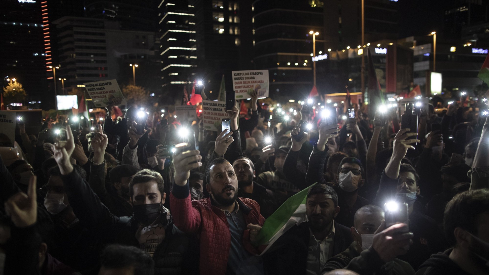 epa09188618 People hold phone lights and shout slogans during a protest against Israel in front of the Israel Consulate in Istanbul, Turkey, late 09 May 2021. The Israeli Supreme Court had postponed the 10 May hearing into the ruling by an Israeli court in East Jerusalem that ordered the forced eviction of six Palestinian families from their homes in Sheikh Jarrah neighborhood in favor of Jewish families who claimed they used to live in the houses before fleeing in the 1948 war that led to the creation of Israel. Thousands of Israelis, including right-wing groups, are expected to join the &#039;Flag March&#039; on 10 May which is considered &#039;Jerusalem Day&#039;, an Israeli national holiday that celebrates the establishment of Israeli control over the Old City in the aftermath of the June 1967 Six-Day War. The Flag March route goes through the old city quarters and Damascus gate, ending at the Western Wall.  EPA/ERDEM SAHIN