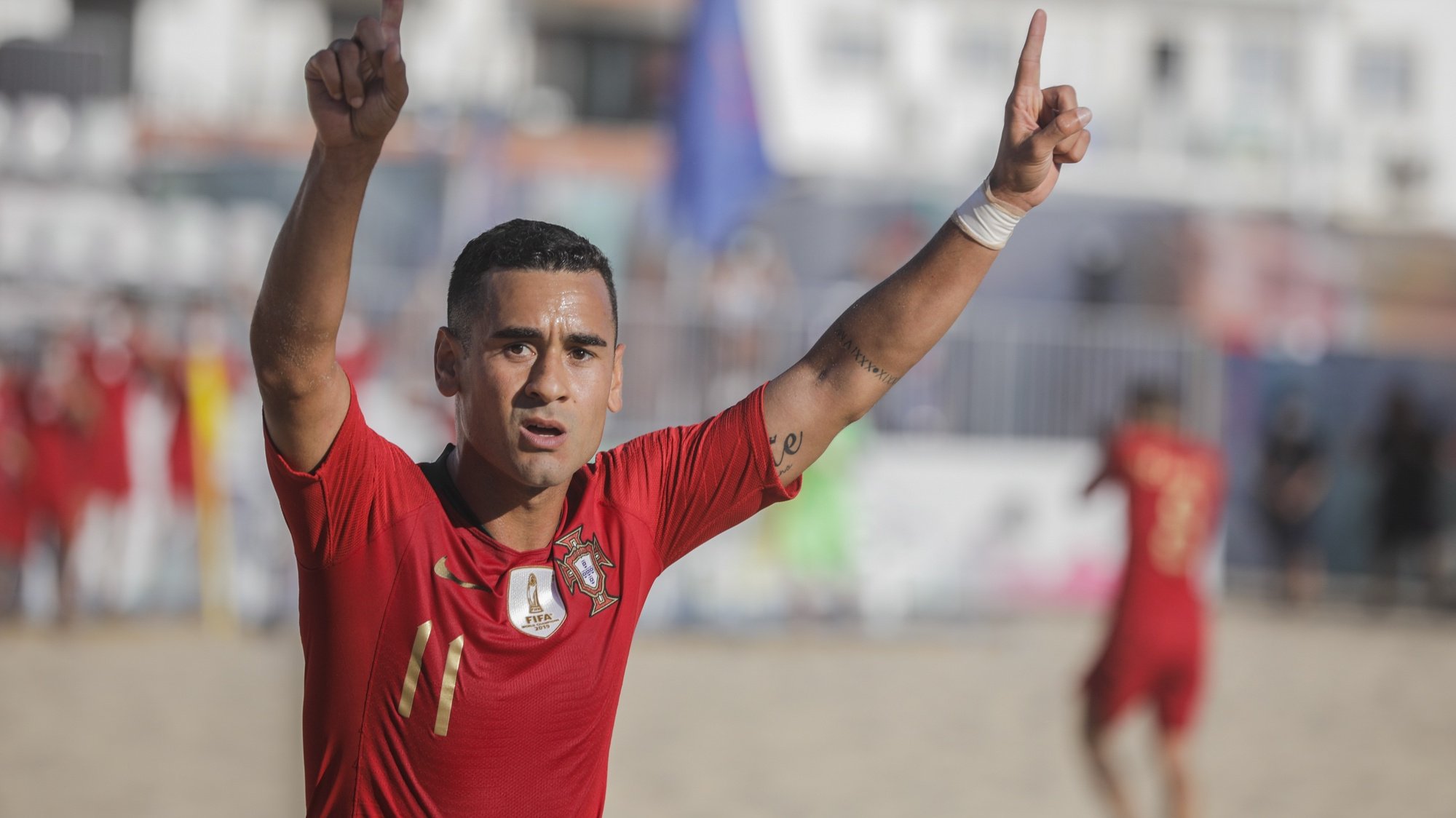 epa08651301 The player of the Portugal national team Leo Martins celebrates the scoring of a goal against the Swiss national team during the Superfinal of the European Beach Soccer League held at Nazare, Portugal, 6th September 2020.  EPA/PAULO CUNHA