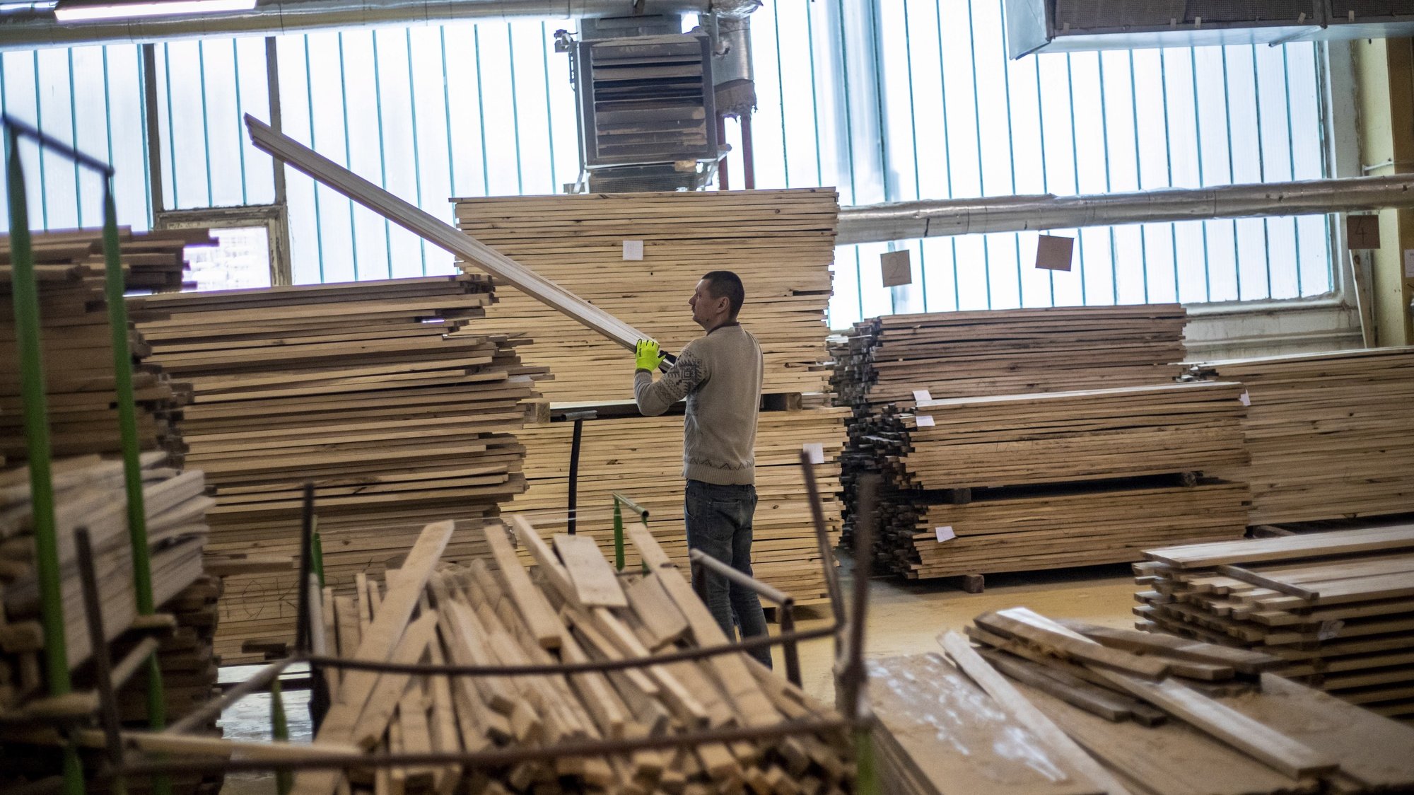 epa09007207 A worker carries timber for coffins at the Setora coffin factory in Pocatky, Czech Republic, 11 February 2021 (issued 12 February 2021). The town of Pocatky (Czech for ‘Beginnings’) is, perhaps ironically, home to the country’s largest manufacturer of coffins, Setora, which in 1991 took over Lisek, a former cooperative that had been building wooden caskets since 1949. The company has seen a boost in production and sales figures since the Covid-19 pandemic struck last year, making around a hundred wooden coffins daily. The country has the world’s second highest mortality rate per 100,000 people, according to Johns Hopkins University.  EPA/MARTIN DIVISEK