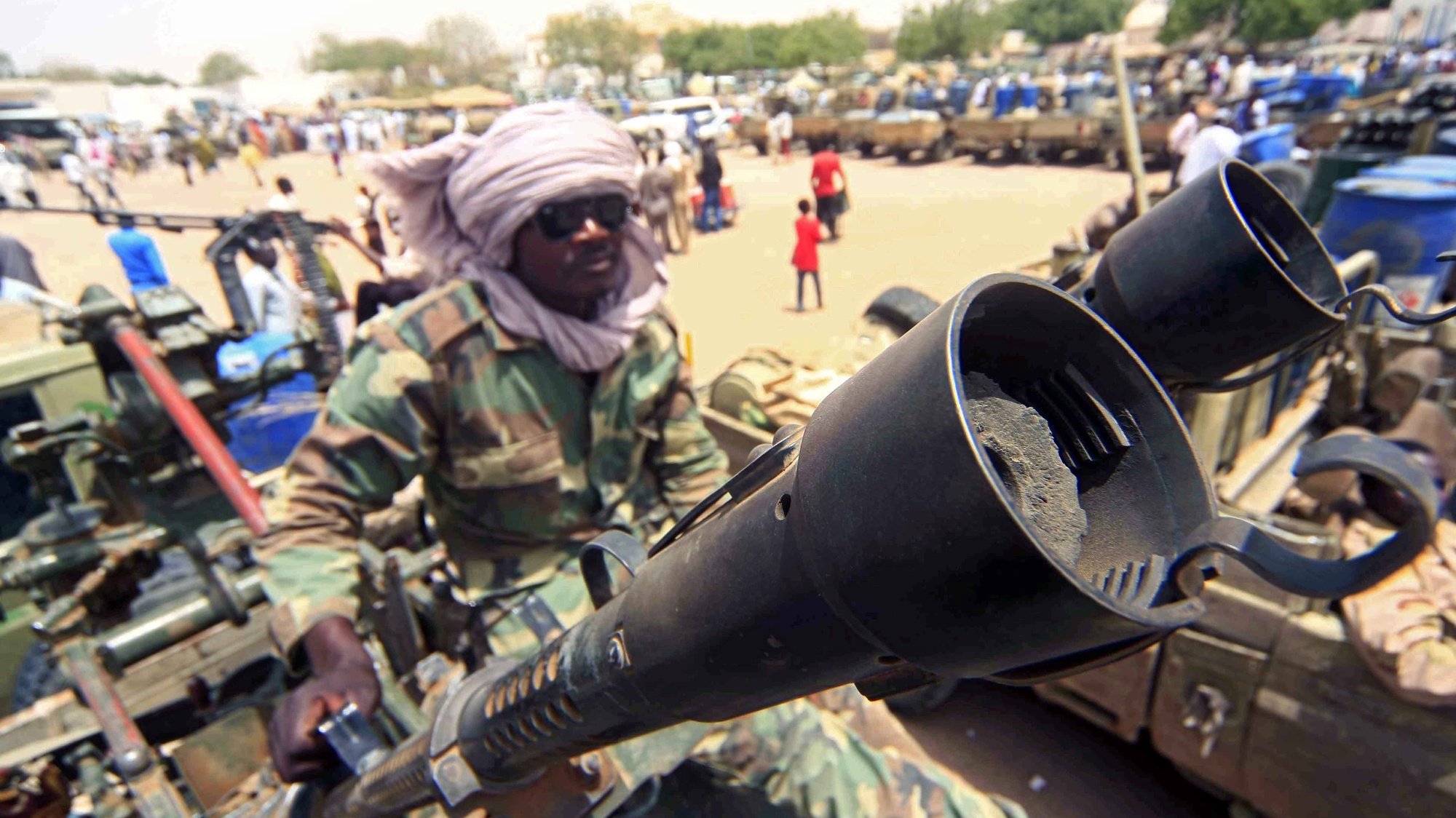 epa08636963 (FILE) - A militia members sits beside military equipment allegedly seized during a battle in the contested area of south Darfur, Nyala, Sudan, 04 May 2015 (reissued 31 August 2020). The Sudanese government and rebel groups on 31 August 2020 will hold a formal signing ceremony after they agreed on a peace deal.  EPA/MARWAN ALI *** Local Caption *** 51917573