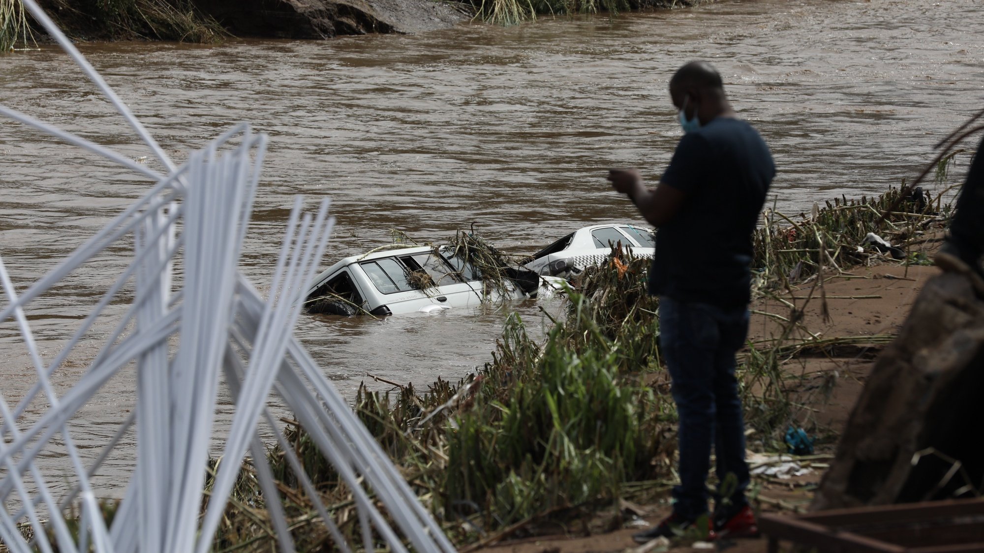 epa09886248 Two cars are submerged in flood waters near Durban, South Africa, 12 April 2022. At least 45 people have died as a result of heavy flooding in the Eastern Coastal area. Key roads in the area have been damaged and as mudslides destroyed houses. The South African National Defense Force have been called in to assist.  EPA/STR