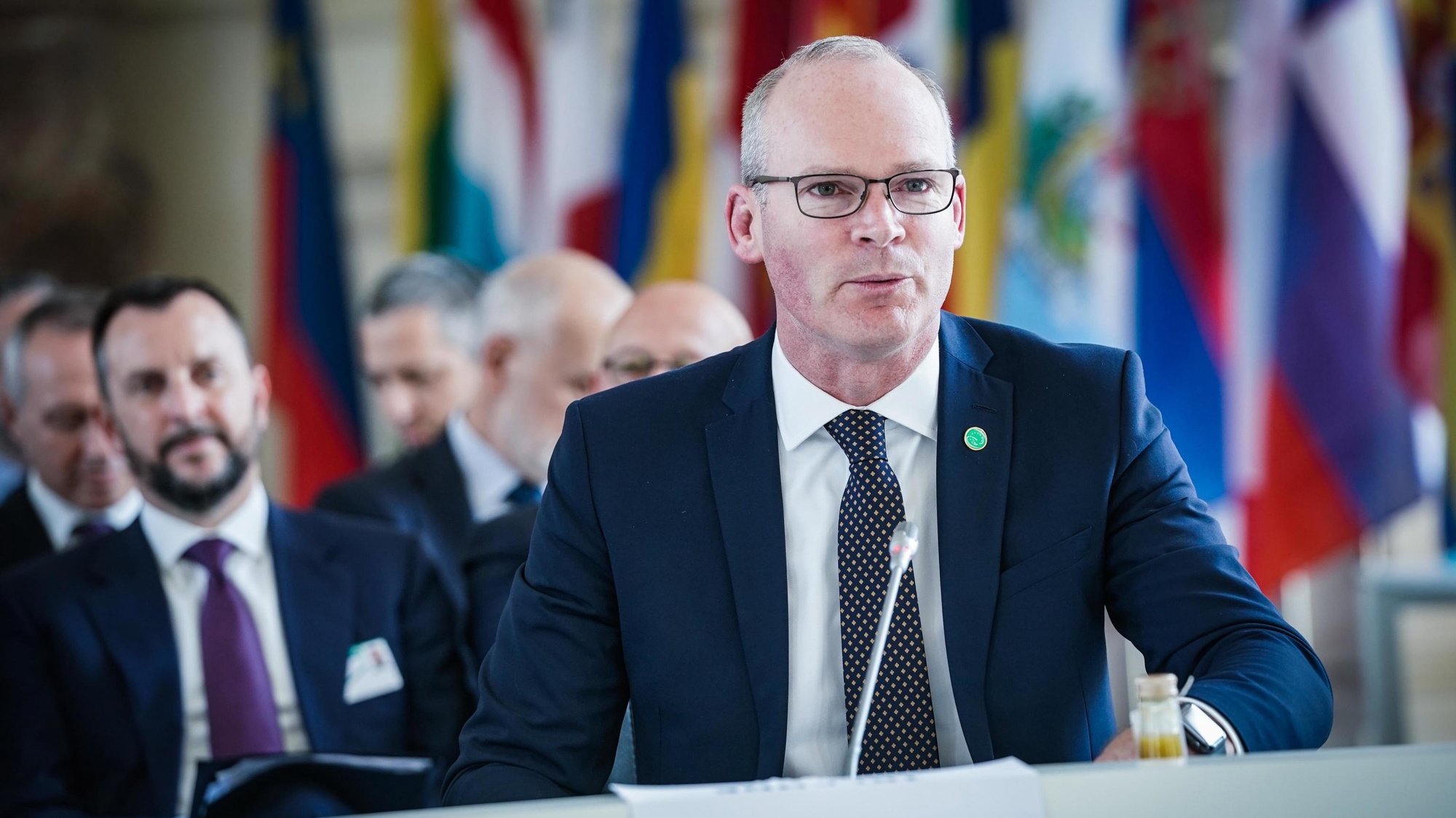epa09960063 Irish Minister of Foreign Affairs Simon Coveney (R) speaks during the 132nd session of the Committee of Foreign Ministers of the Council of Europe at the Reggia di Venaria Reale in Turin, Italy, 20 May 2022.  EPA/Tino Romano