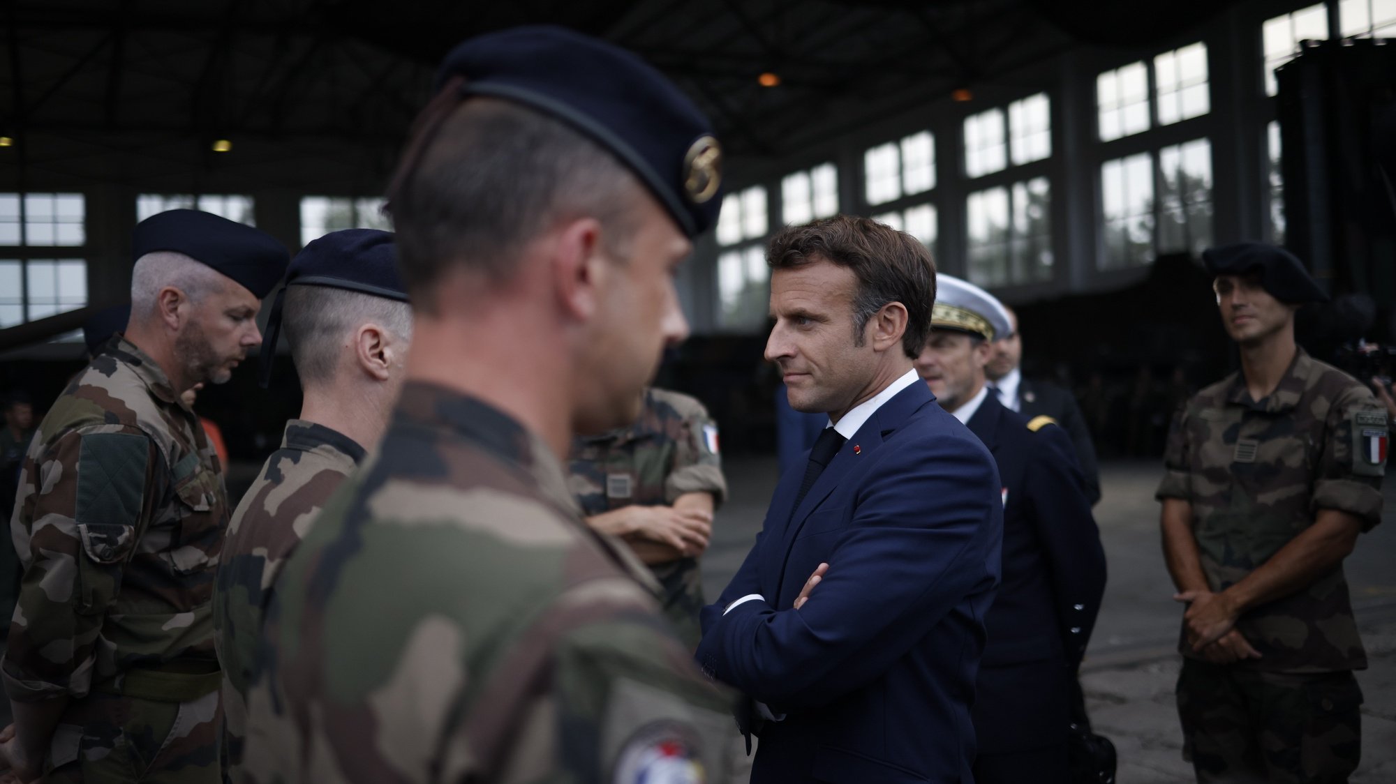 epaselect epa10012939 French President Emmanuel Macron (C), greets French soldiers on his arrival at the Mihail Kogalniceanu Air Base, near the city of Constanta, Romania, 14 June 2022. French President Macron will make a visit to the airbase. French and Belgian troops are deployed in Romania with the NATO Response Force as part of Mission AIGLE.  EPA/YOAN VALAT / POOL
