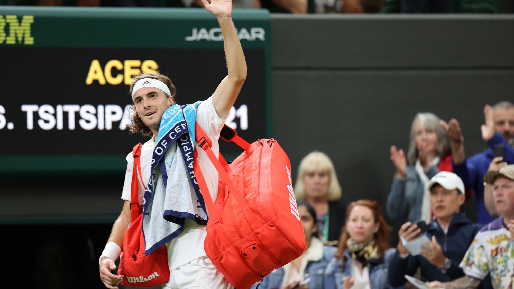 epa10048623 Stefanos Tsitsipas of Greece waves as he leaves after losing to Nick Kyrgios of Australia during their Men&#039;s third round match at the Wimbledon Championships, in Wimbledon, Britain, 02 July 2022.  EPA/KIERAN GALVIN   EDITORIAL USE ONLY
