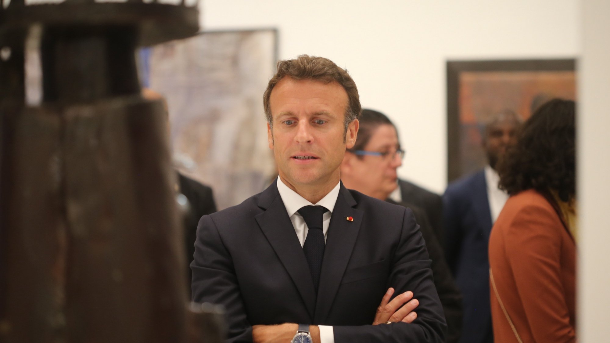 epa10094144 French President Emmanuel Macron attends the opening of a hybrid art exhibition in Cotonou, Benin, 27 June 2022, during the official visit of Macron to the Republic of Benin.  EPA/AKINTUNDE AKINLEYE