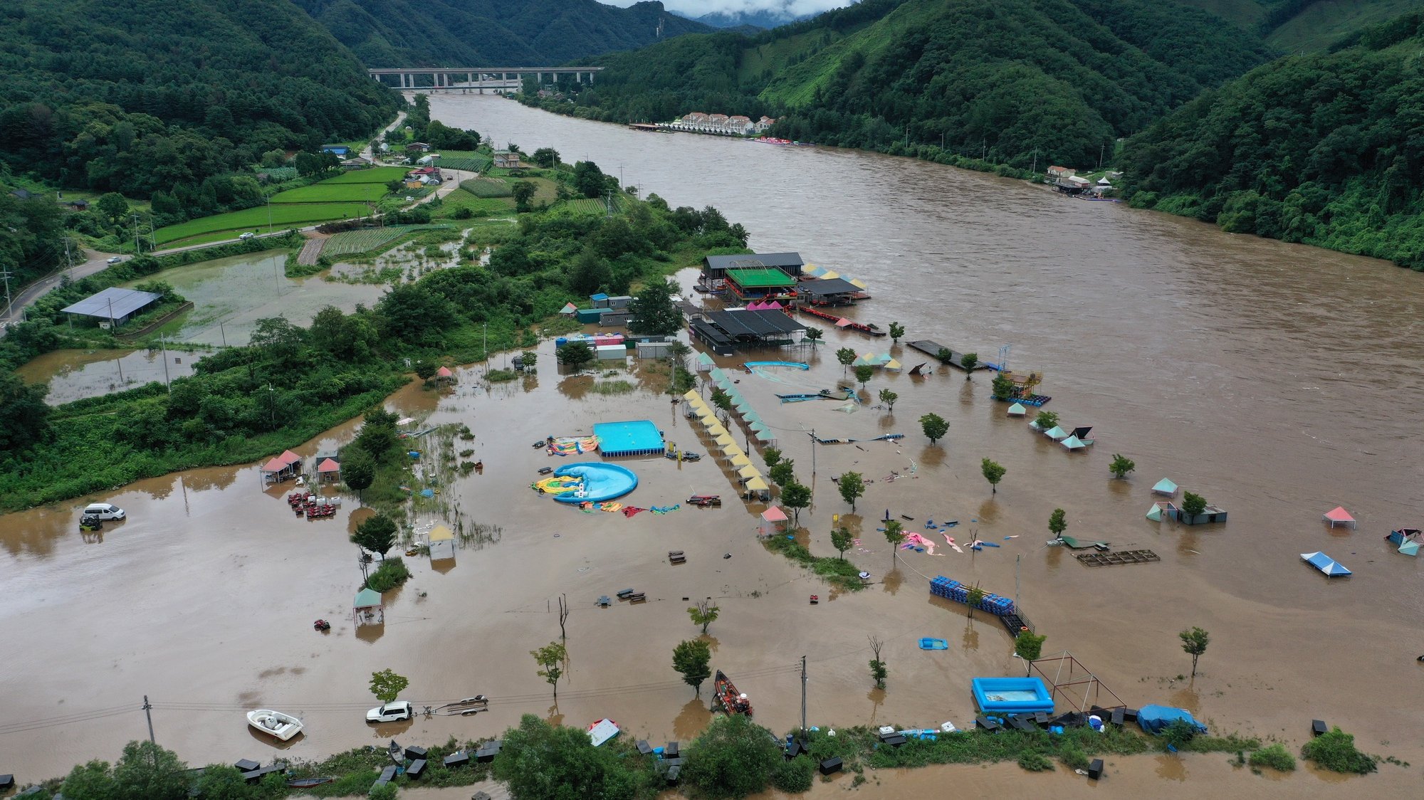 epa10113367 Muddy water floods a swimming area as a nearby river overflowed amid torrential rain, in Chuncheon, 75 kilometers northeast of Seoul, South Korea, 10 August 2022.  EPA/YONHAP SOUTH KOREA OUT