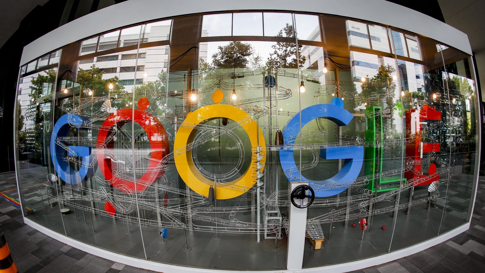 epa08873751 (FILE) A  picture made with a fisheye lens shows the Google logo in Singapore, 06 December 2019 (reissued 10 December 2020). According to media reports on 10 December 2020, French data privacy regulator CNIL will impose over 100 million euros fines on US companies Google and Amazon for breaching EU privacy data rules. According to media reports, Google will have to pay 100 million euros and Amazon 35 million euros fines.  EPA/WALLACE WOON *** Local Caption *** 55685412