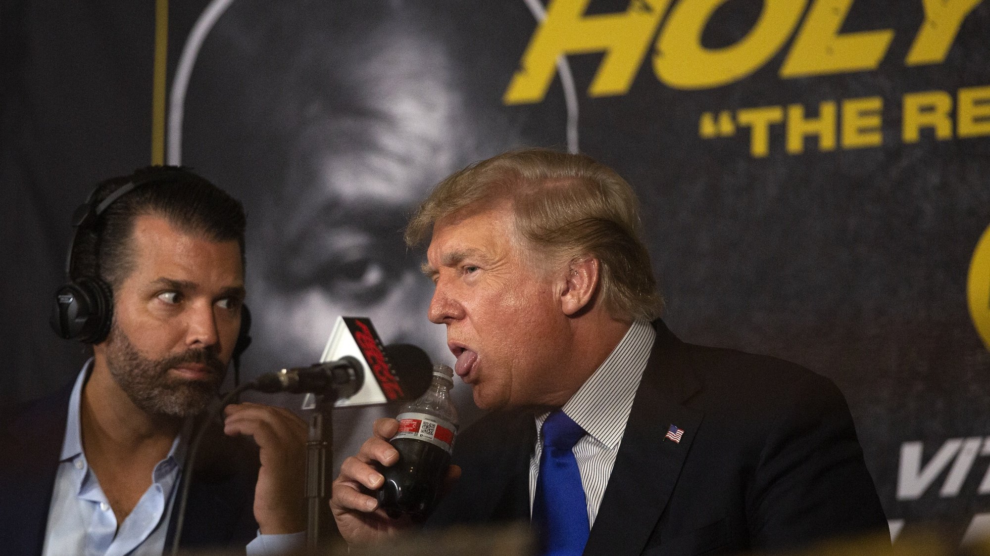 epa09462855 Former US President Donald J. Trump (R), with his son Donald Trump Jr. (L), attends the Former Heavyweight boxing champion Evander Holyfield against Former UFC Heavyweight World Champion Vitor Belfort &#039;Legends II&#039; Heavyweight match in Hard Rock LIVE at Seminole Hard Rock Hotel and Casino in Hollywood, Florida, USA, 11 September 2021.  EPA/CRISTOBAL HERRERA-ULASHKEVICH