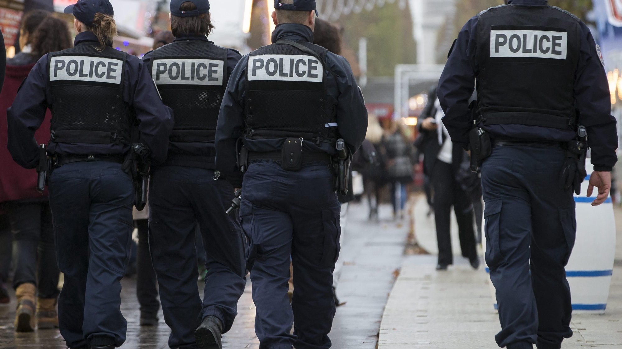 epa05033098 French police officers patrol the outdoor Christmas market on the renowned Avenue des Champs-Elysees in Paris, as part of the state-of-emergency and heightened security measures in Paris following the 13 November attacks, in Paris, France, 19 November 2015. Paris suffered terrorist attacks at the hands of the so-called Islamic State on November 13, when Islamist suicide bombers and gunmen claimed the lives of 129 people, and injured 352.  EPA/IAN LANGSDON