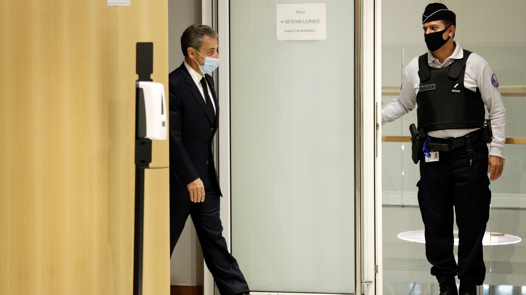 epaselect epa08843473 Former French president Nicolas Sarkozy (C) leaves the courtroom during his trial on corruption charges in the so-called &#039;wiretapping affair&#039; in Paris, France, 26 November 2020. In 2013, Nicolas Sarkozy was using a false name, Paul Bismuth, to make phone calls to call his lawyer, Thierry Herzog, about the decision that the Court of Cassation was about to take regarding the seizure of presidential diaries in a separate case. The trial is due to run from 23 November to 10 December.  EPA/YOAN VALAT *** Local Caption *** 55512057