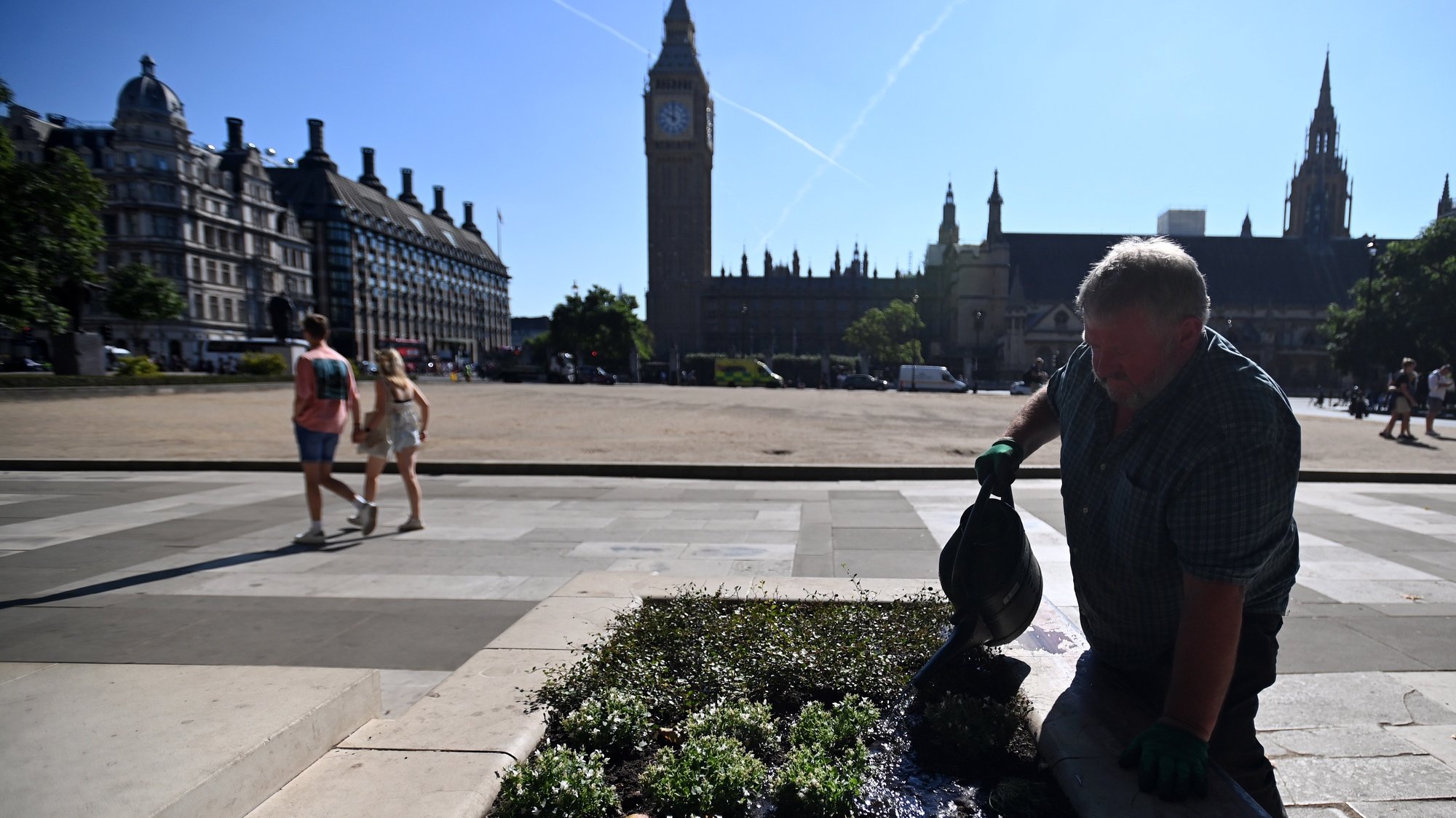 epa10112638 A worker waters plants at Parliament Square in London, Britain 09 August 2022. Britain is likely to suffer drought conditions until October as the dry weather continues. The UK Met Office has announced an amber alert for extremely hot weather. Meanwhile Thames Water which operates London&#039;s water supply has announced a hosepipe ban in order to save water.  EPA/ANDY RAIN