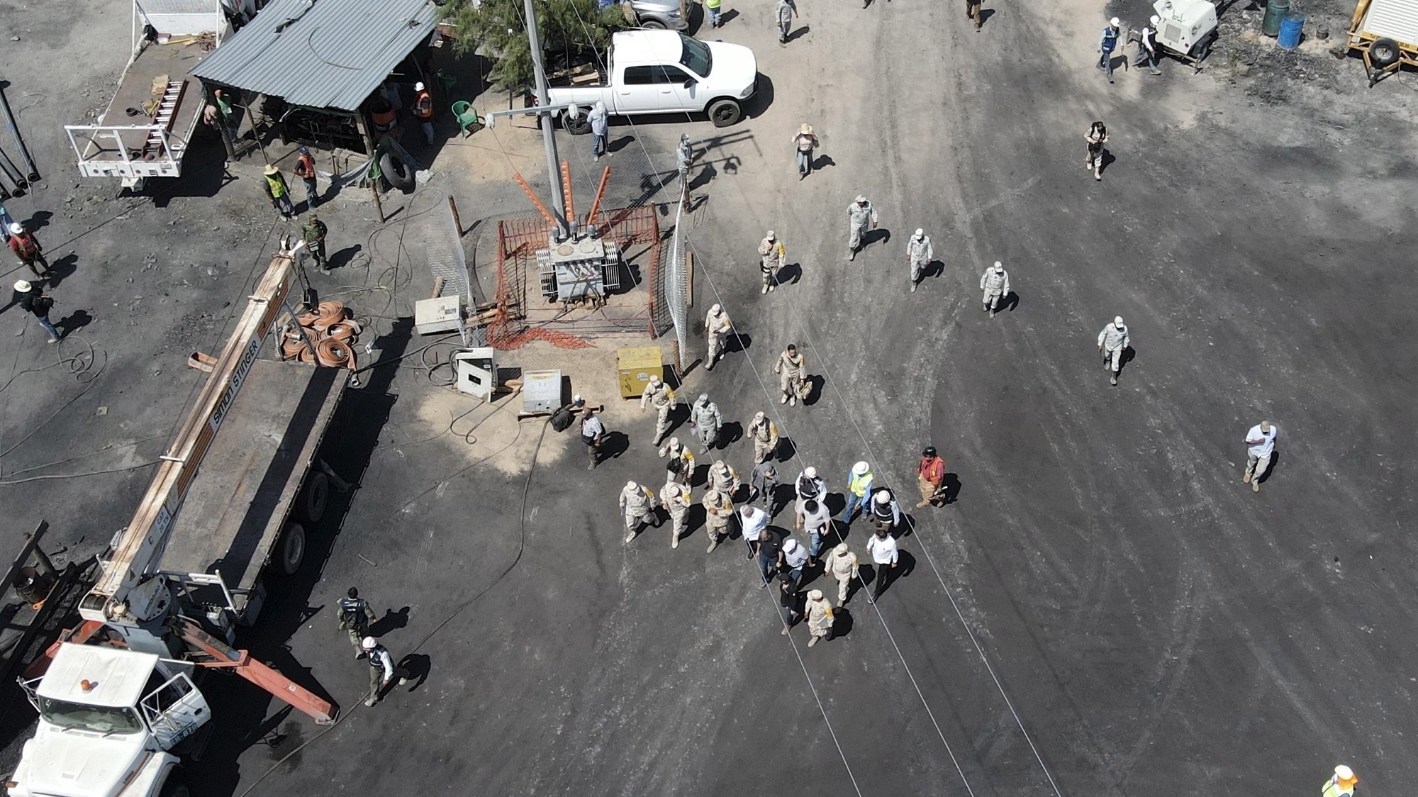 epa10110968 Photograph taken with a drone shows the arrival of the president of Mexico AndrÃ©s Manuel LÃ³pez Obrador to the area where 10 miners are trapped in the municipality of Sabinas in Coahuila, Mexico, 07 August 2022. LÃ³pez Obrador said that the priority is to rescue the 10 miners who since Wednesday were trapped in a mine in Sabinas, Coahuila, in the north of the country after a landslide.  EPA/Antonio Ojeda