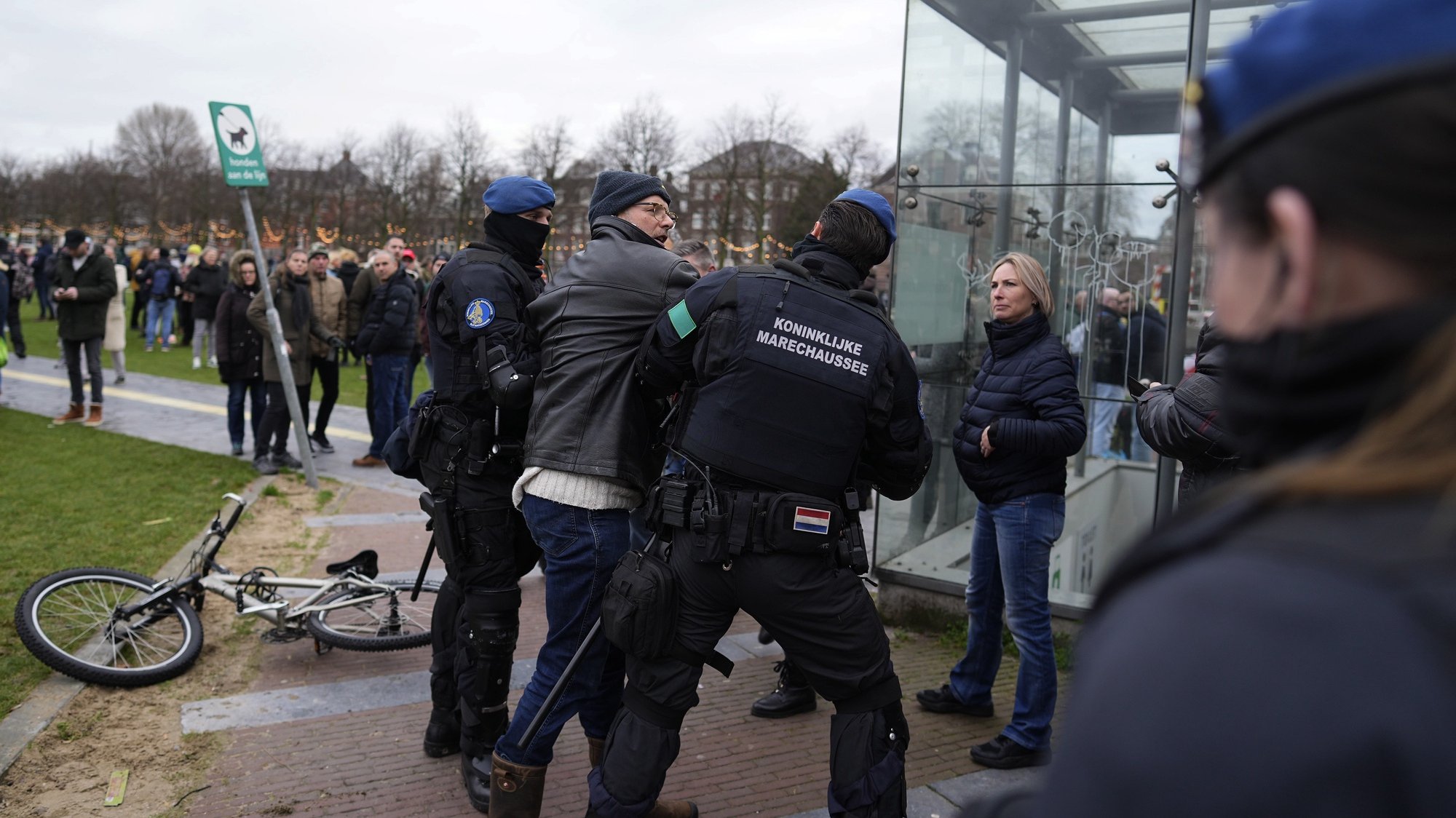 epa09663743 Dutch national police detains a protester as people gathered at the Museumplein to demonstrate against the government-imposed lockdown measures to curb the spread of the Sars-CoV-2 coronavirus, despite the municipality&#039;s ban on a demonstration of Samen voor Nederland (Together for the Netherlands) in Amsterdam, Netherlands, 02 January 2022. Dutch authorities have previously sent out an urgent appeal to Samen voor Nederland (Together for the Netherlands) and demonstrators not to come to Amsterdam, otherwise security forces will be forced to intervene. The Netherlands enforced a hard lockdown from 19 December 2021 until at least 14 January 2022 to curb the rapid spread of the Omicron variant of SARS-CoV-2.  EPA/PHIL NIJHUIS
