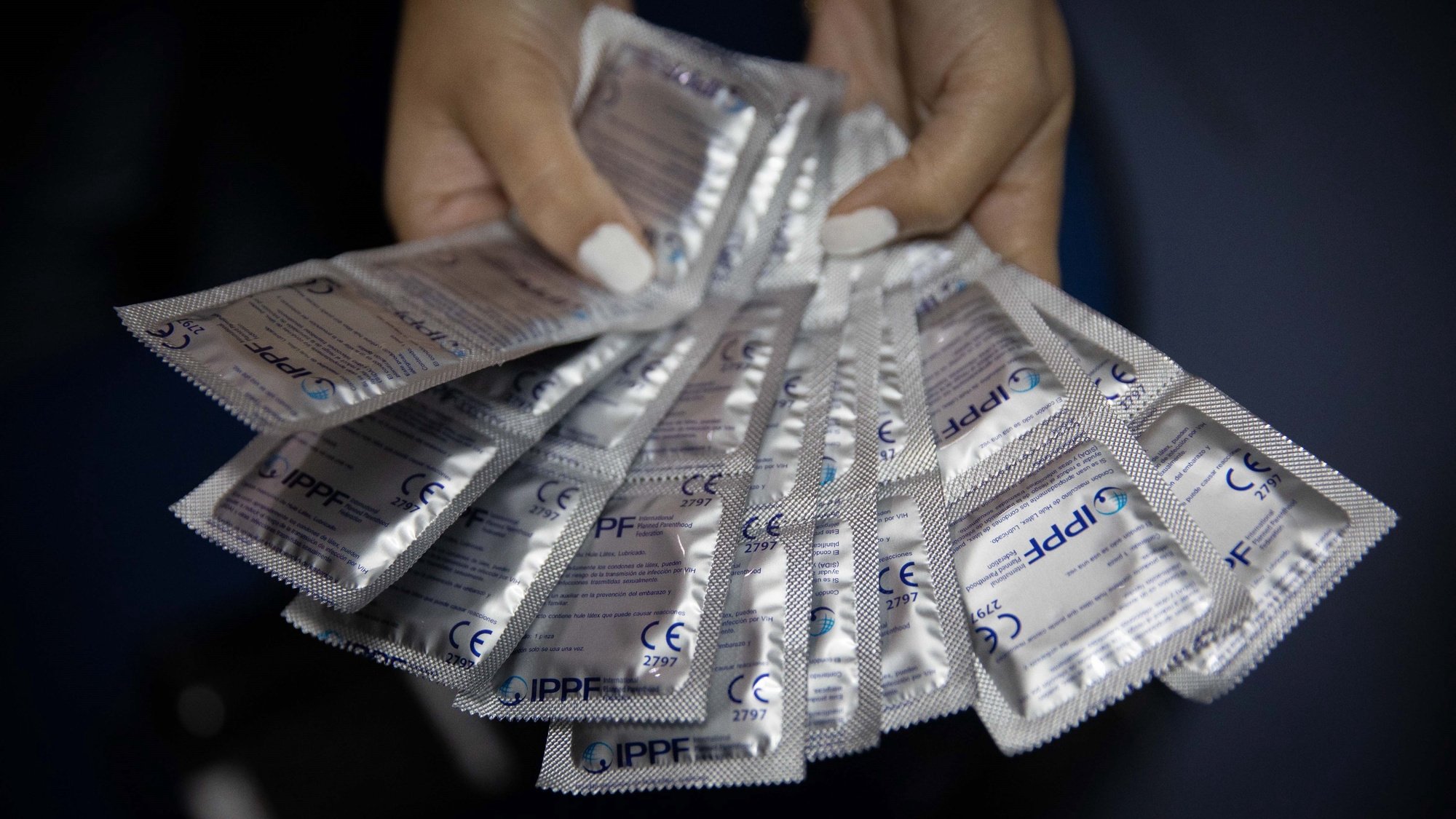 epa09467939 A social worker shows condoms before a donation at the Plafam Clinic in Caracas, Venezuela, 13 September 2021 (issued 14 September 2021). The shortage of contraceptive methods in Venezuela and their high costs have become an obstacle to family planning, thus causing, according to various organizations and experts, a violation of women&#039;s sexual and reproductive rights.  EPA/RAYNER PENA R