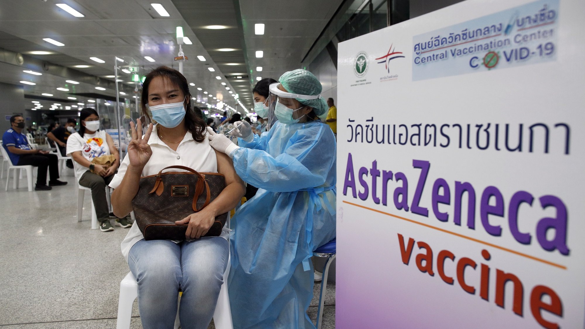 epa09485160 A Thai woman gestures while receiving a dose of AstraZeneca (Vaxzevria) vaccine for the third booster vaccination against COVID-19 at Bang Sue Central Vaccination Center in Bangkok, Thailand, 24 September 2021. Thailand rolled out third vaccination injections as a booster shot against COVID-19 for the public with AstraZeneca (Vaxzevria) vaccine amid the prolonged surge of COVID-19 infections. The Thai government plans to fully vaccinate 50 million people by the end of 2021, according to the Health Minister.  EPA/RUNGROJ YONGRIT (RESEND)