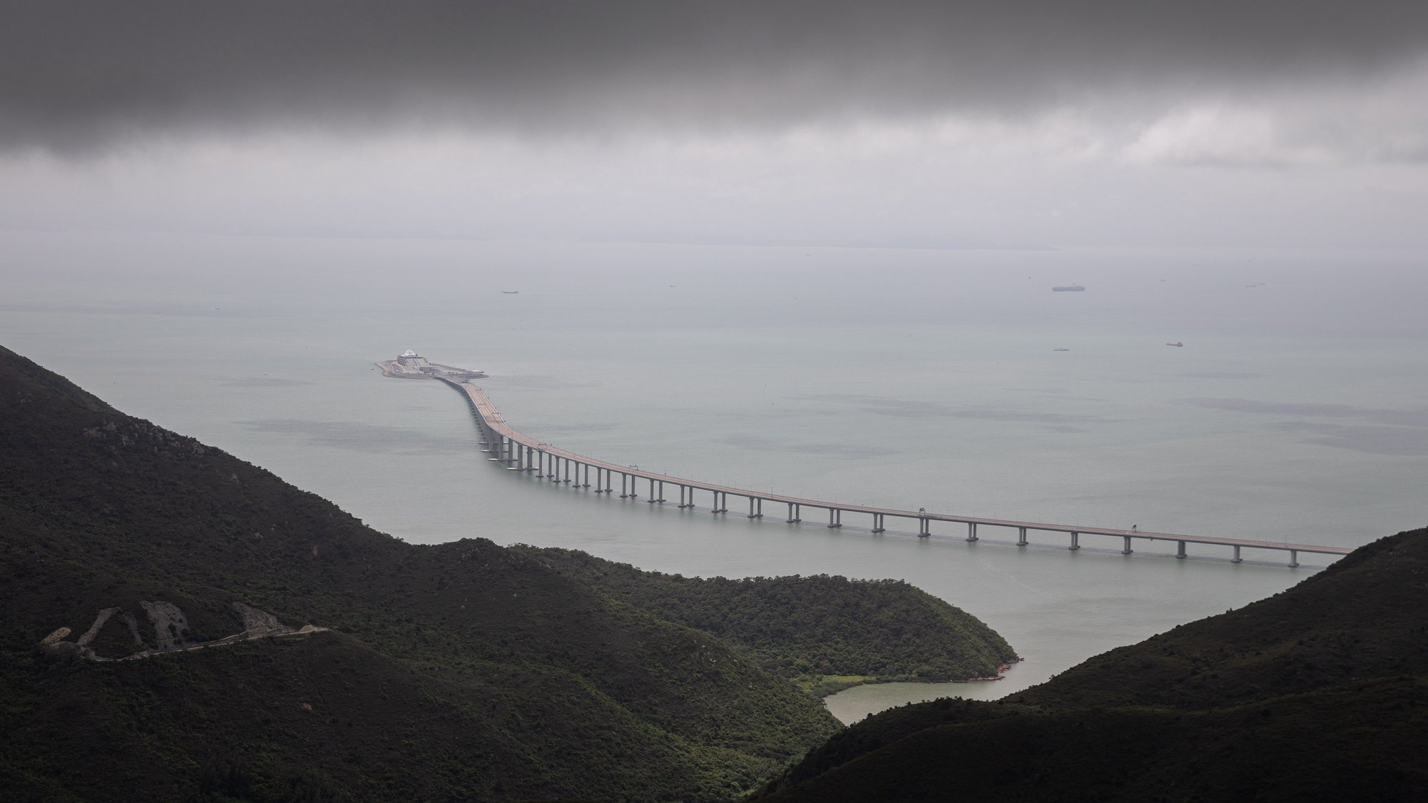 epa09269619 The Hong Kong Link Road of the Hong Kong-Zhuhai-Macau Bridge, (HZMB) spans over the South China Sea in Hong Kong, China, 14 June 2021. The HZMB is 55-kilometre long and consists of a series of bridges, an undersea tunnel and four artificial islands connecting Hong Kong, Macau and Zhuhai in China.  EPA/JEROME FAVRE