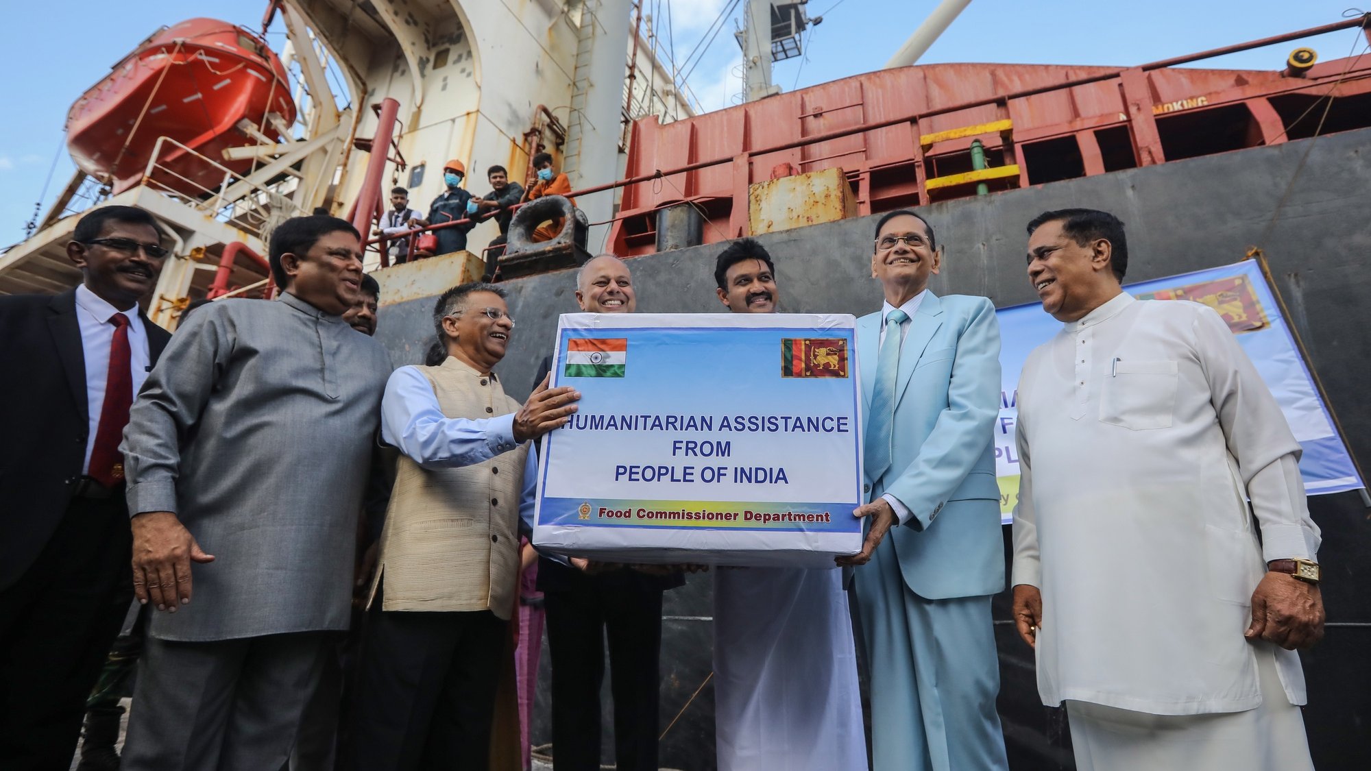 epa09966147 Indian High Commissioner to Sri Lanka Gopal Baglay (3-L) officially hands over a consignment of humanitarian aid granted by the Government of India to Sri Lankan Foreign Minister Gamini Lakshman Peiris (2-R) at the Port in Colombo, Sri Lanka, 22 May 2022. The Indian Government granted a consignment of milk powder, rice, and emergency medicines to Sri Lanka as emergency supplies to assist in the current economic crisis on May 22. Sri Lanka faces its worst economic crisis in decades due to the lack of foreign exchange, resulting in severe shortages in food, fuel, medicine, and imported goods.  EPA/CHAMILA KARUNARATHNE