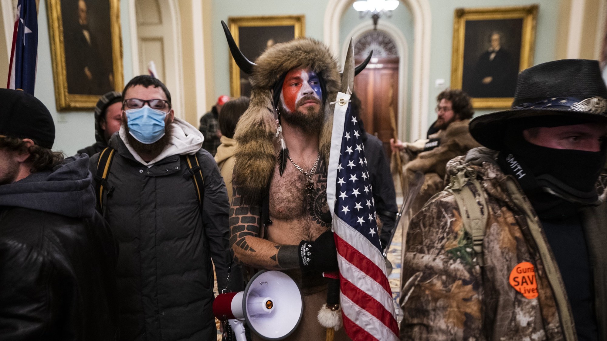 epa08923449 Supporters of US President Donald J. Trump gather outside of the Senate chamber after they breached the US Capitol security in Washington, DC, USA, 06 January 2021. Protesters stormed the US Capitol where the Electoral College vote certification for President-elect Joe Biden took place.  EPA/JIM LO SCALZO