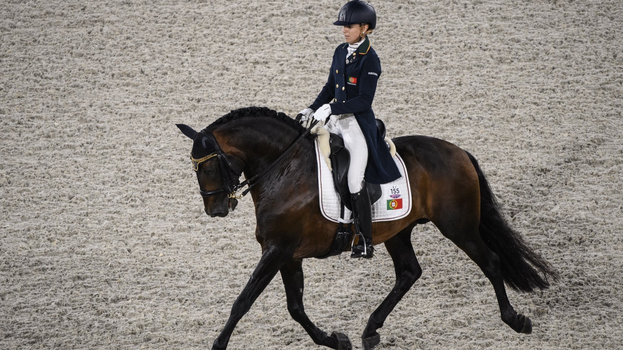 epa09362250 Maria Caetano of Portugal riding Fenix De Tino performs in the Dressage Team competition during the Equestrian events of the Tokyo 2020 Olympic Games at the Baji Koen Equestrian Park in Setagaya, Tokyo, Japan, 24 July 2021.  EPA/CHRISTIAN BRUNA