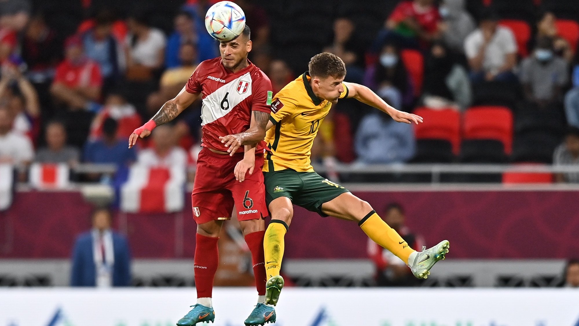 epa10011565 Ajdin Hrustic (R) of Australia in action against Miguel Trauco (L) of Peru during the FIFA World Cup 2022 Intercontinental playoff qualifying soccer match between Australia and Peru in Al Rayyan, Qatar, 13 June 2022.  EPA/Noushad Thekkayil